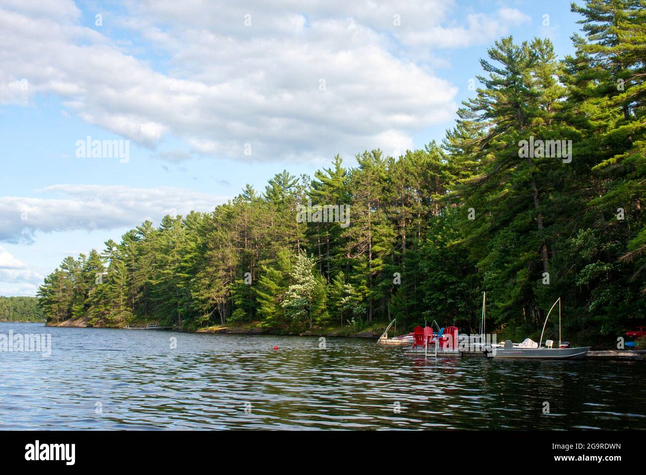 Docks and boats along the water of a lake in Muskoka, Ontario Stock Photo