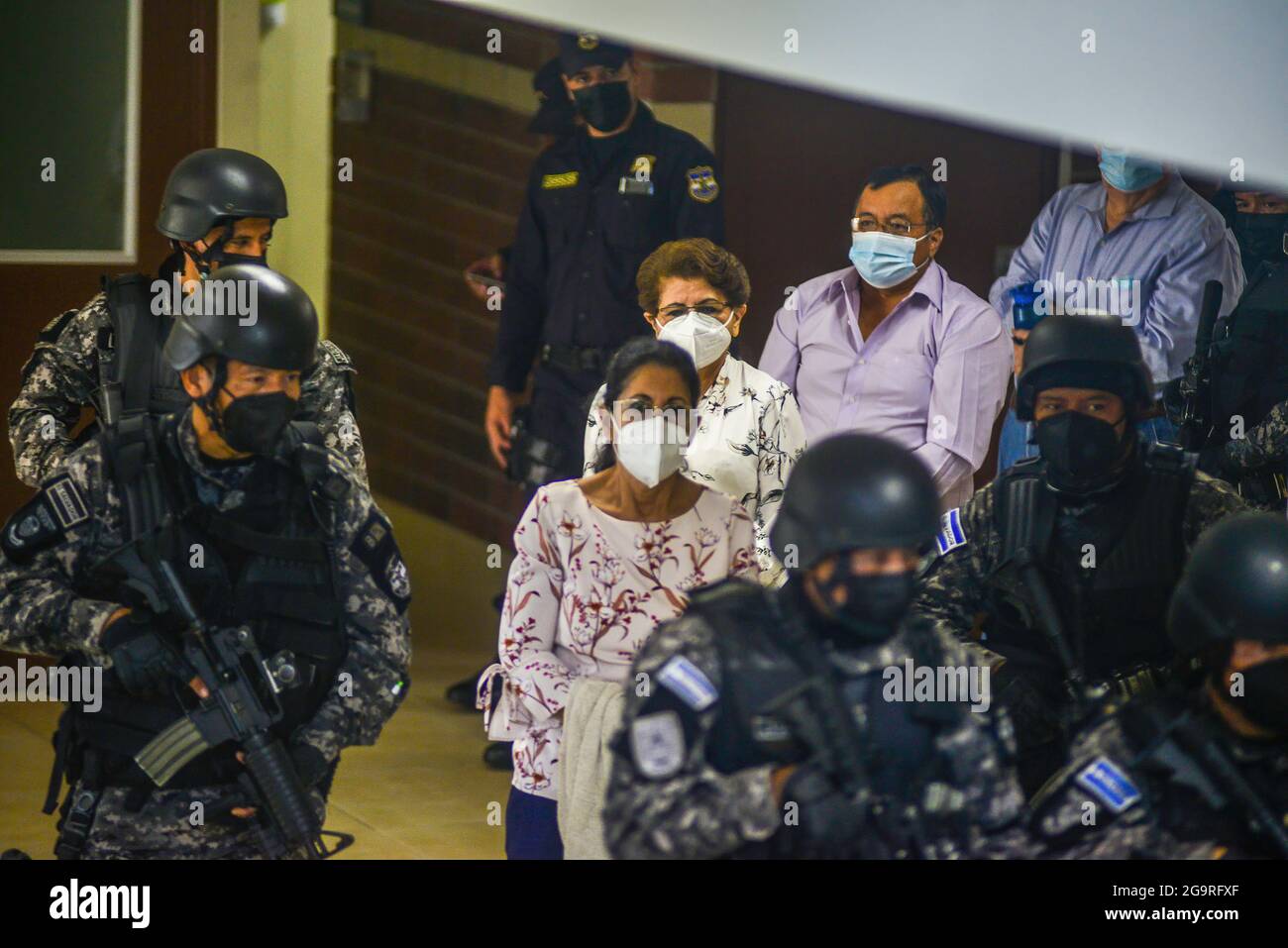 Police officers from a tactical unit escort former government 