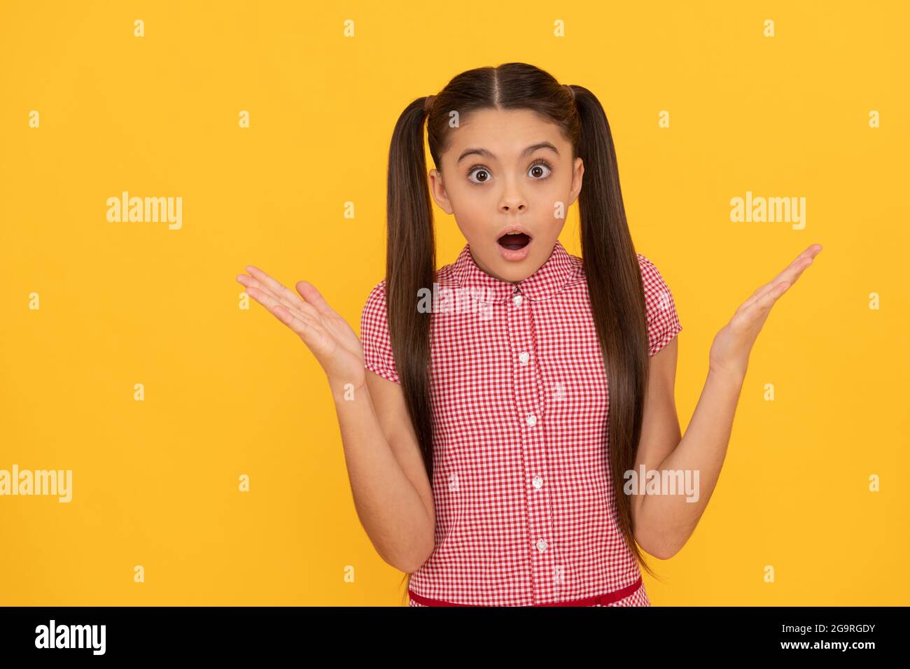 OMG. Surprised child yellow background. Wide-eyed girl got surprised. Surprise and shock Stock Photo