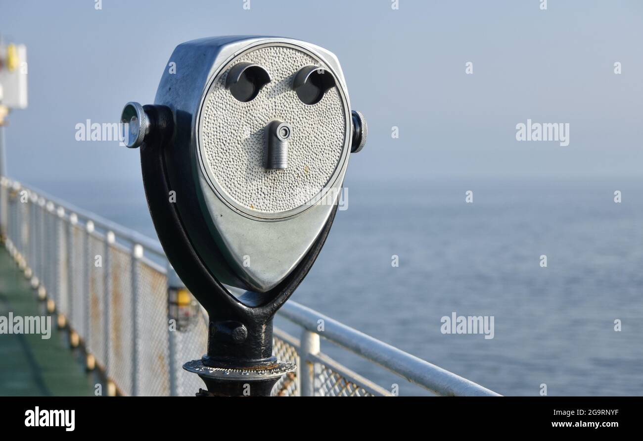 Coin operated tourist binoculars on a ferry boat. Copy space Stock Photo
