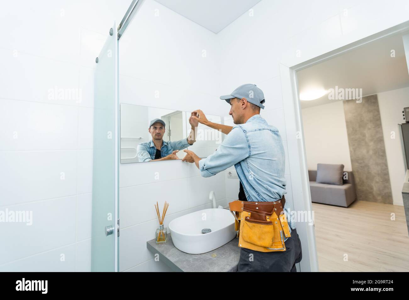 Mirror installer. Installing a mirror.
