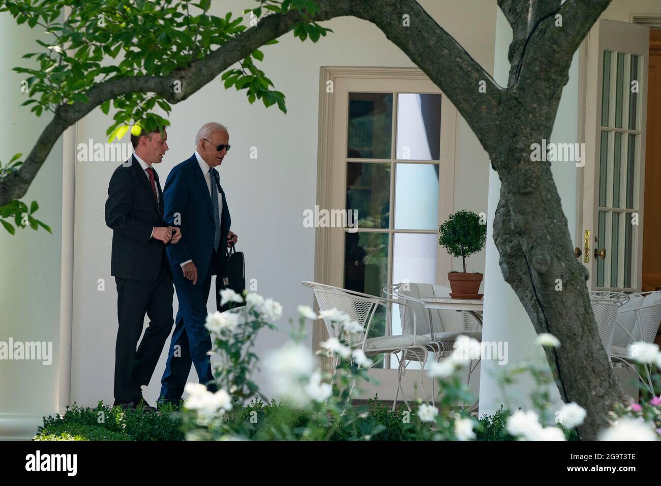 U.S. President Joe Biden walks into the Oval Office with Jake Sullivan, National Security Advisor, as Biden returns to the White House after traveling to the Office of the Director of National Intelligence on Tuesday, July 27, 2021 in Washington, DC Credit: Alex Edelman/Pool via CNP /MediaPunch Stock Photo