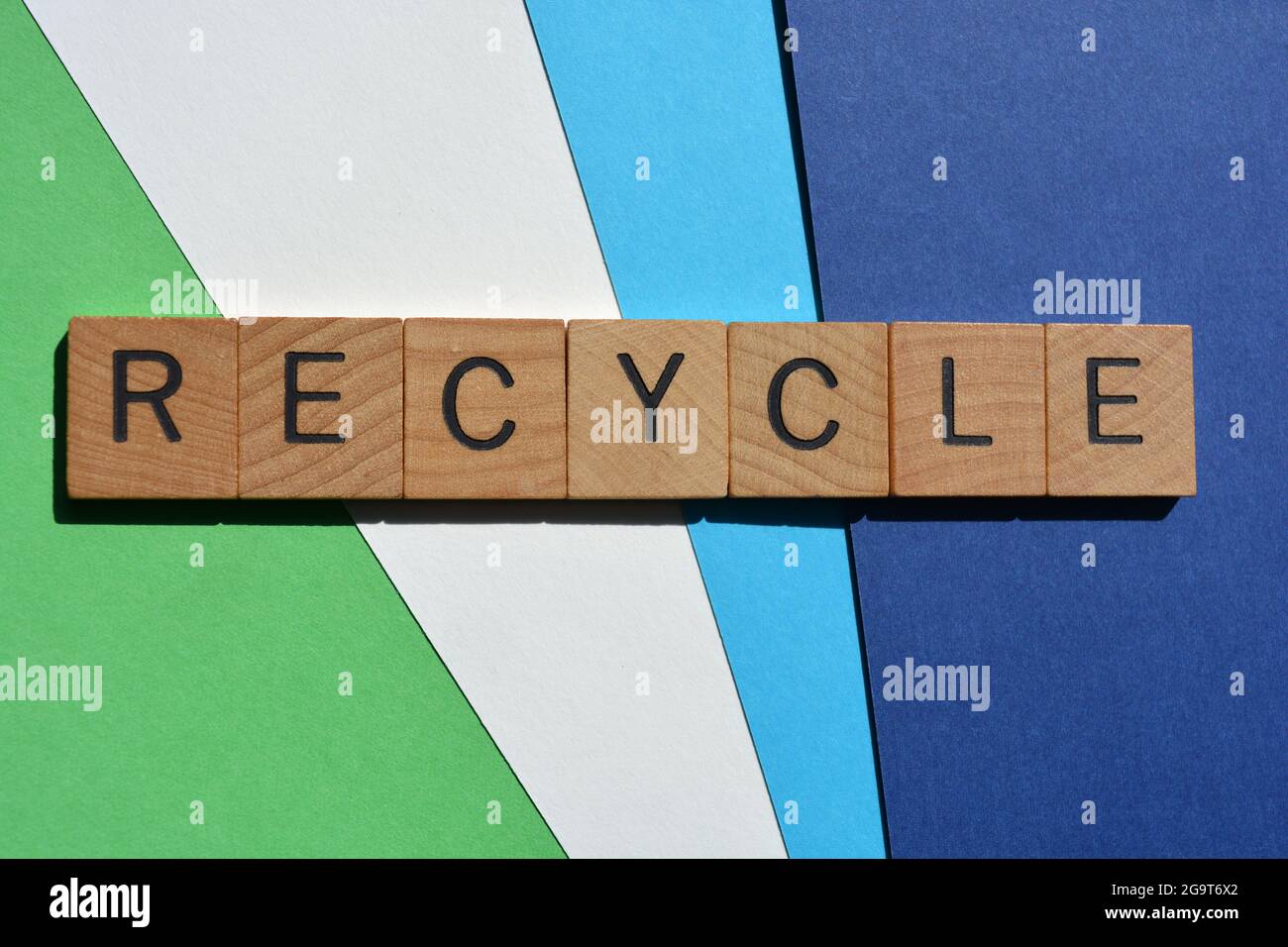 Recycle, word in wooden alphabet letters isolated on blue and green