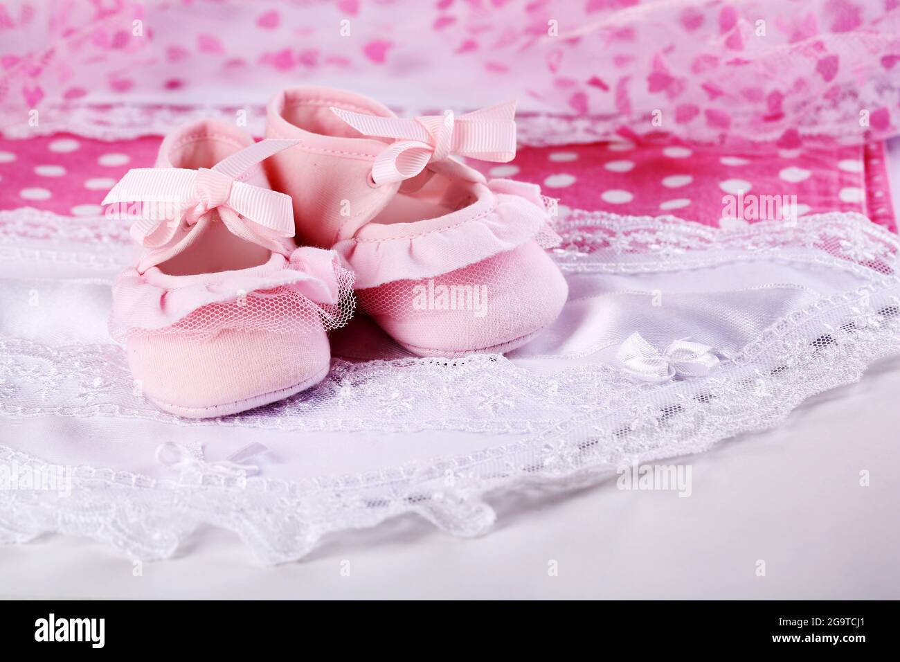 Pink baby boots on cloth closeup Stock Photo Alamy
