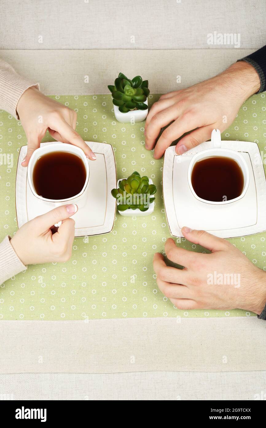Couple hold up tea cups hi-res stock photography and images - Alamy
