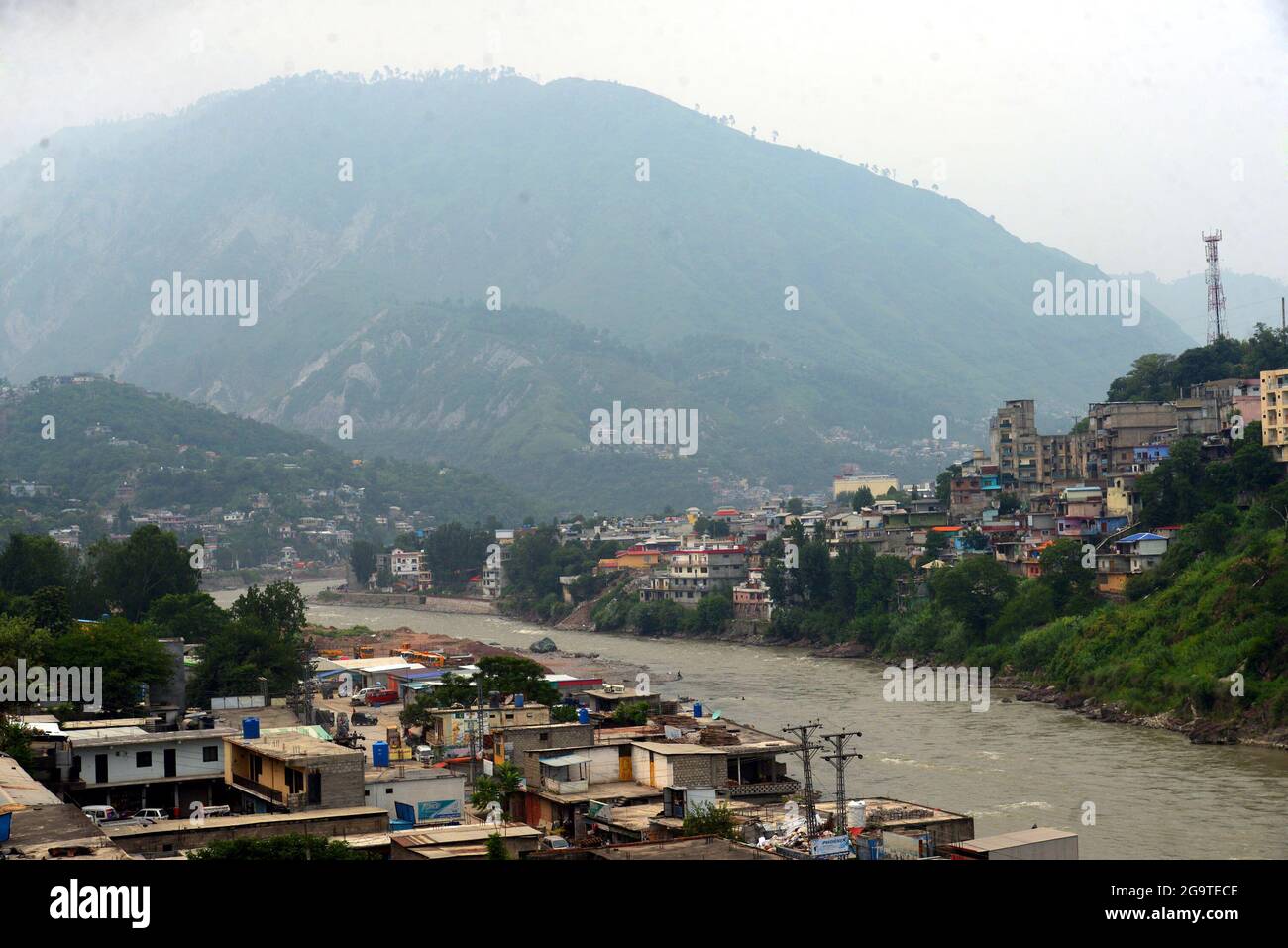 A beautiful view of mountains houses along the Neelam River have huge attraction for tourists from across the Country in Muzaffarabad, Azad Kashmir. Muzaffarabad is the capital and second largest city of Azad Jammu and Kashmir, Pakistan after Mirpur. It is located in Muzaffarabad District on the banks of the Jhelum and Neelum rivers. The Neelum River in the Kashmir region of India and Pakistan. The Neelam River enters Pakistan from India in the Gurais sector of the Line of Control, and then runs west till it meets the Jhelum River north of Muzzafarabad.The Kishenganga was named Neelum either d Stock Photo