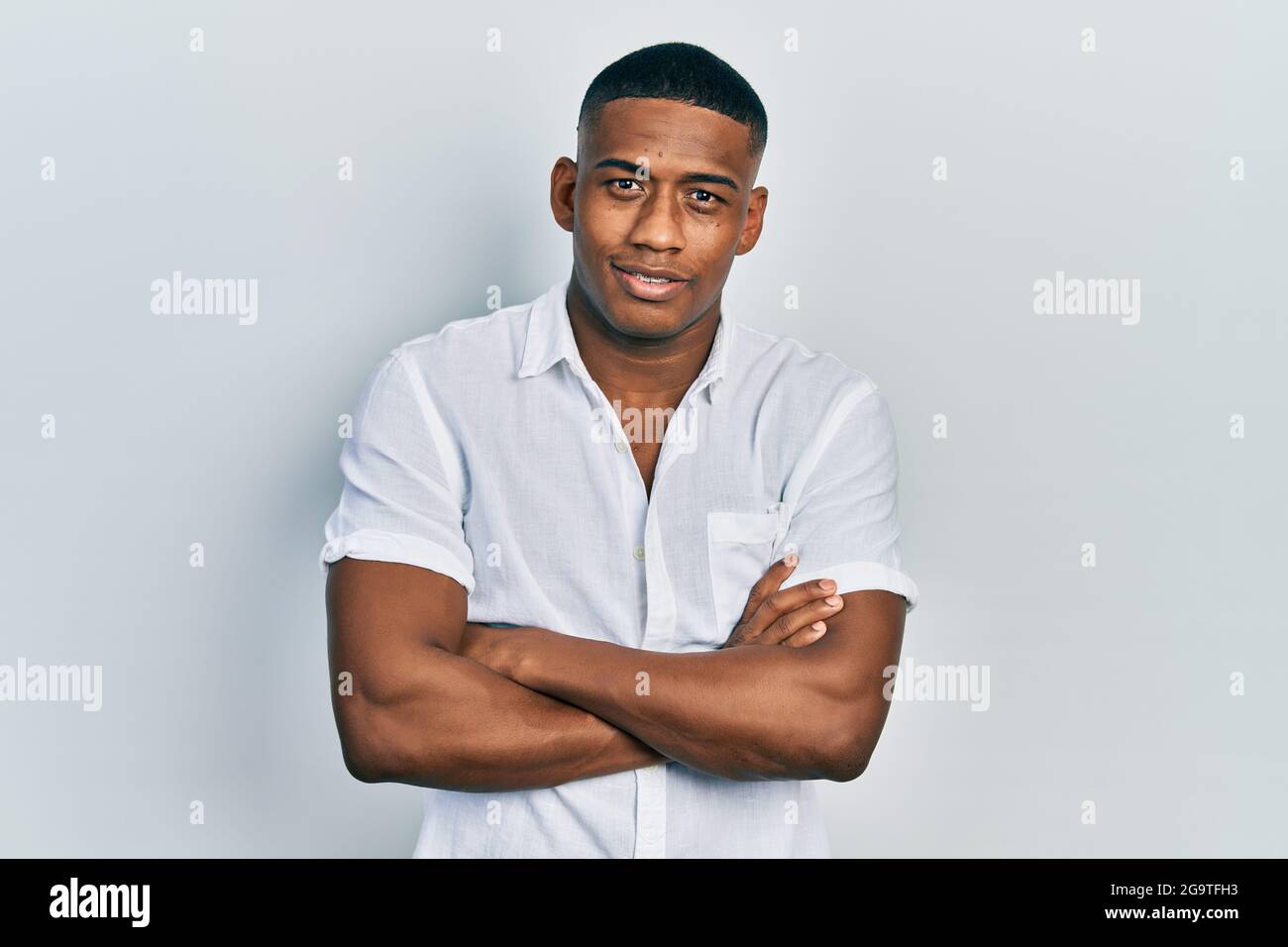 Young black man wearing casual white shirt happy face smiling with ...