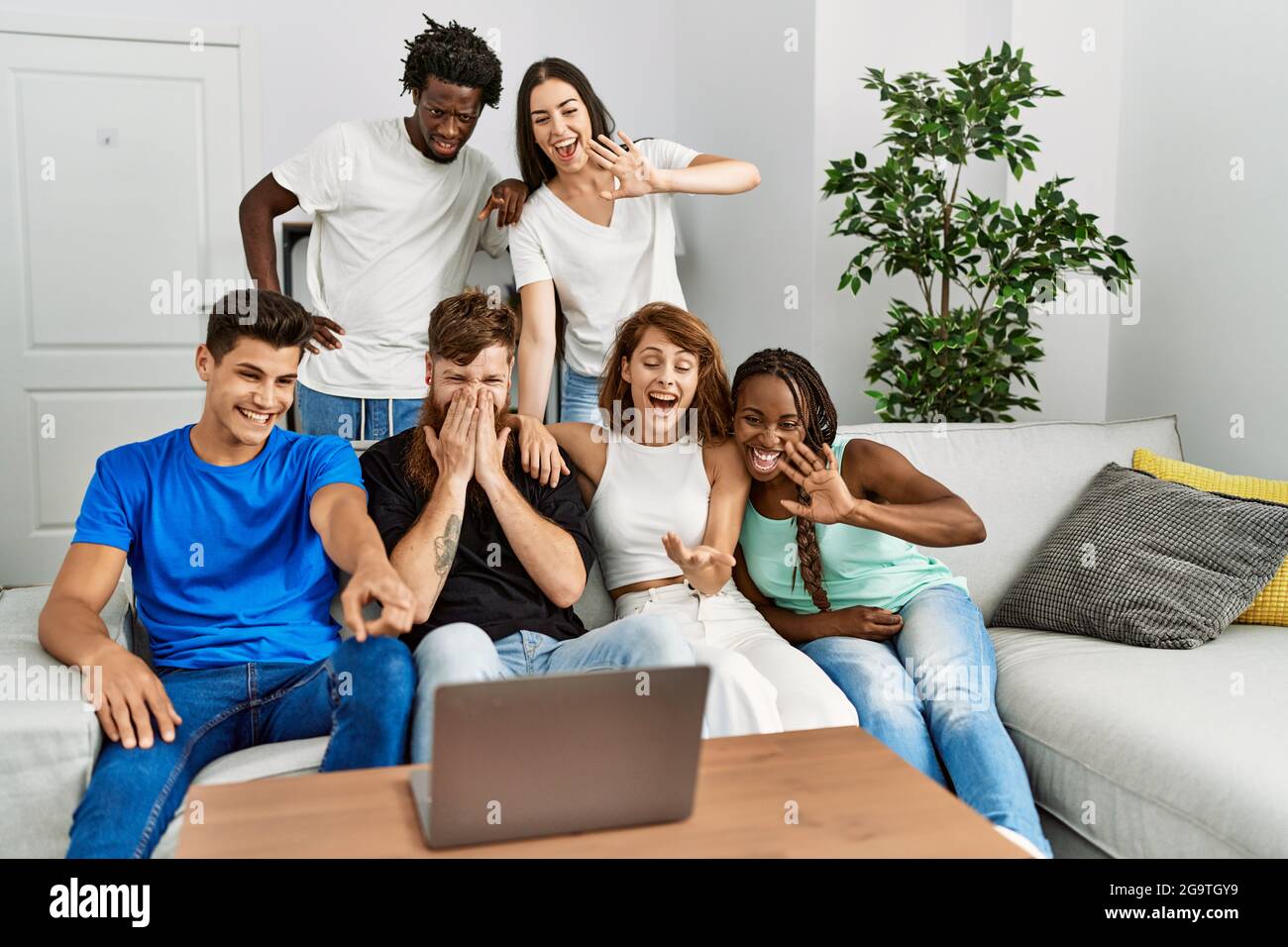 Group of young friends smiling happy having video call using laptop at ...