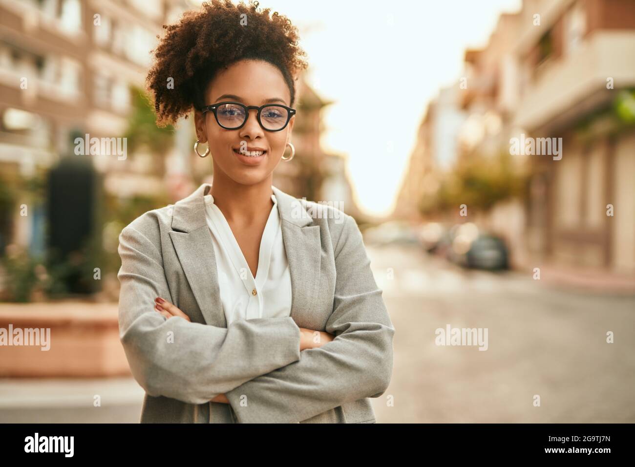 Young african american businesswoman with arms crossed standing at the ...