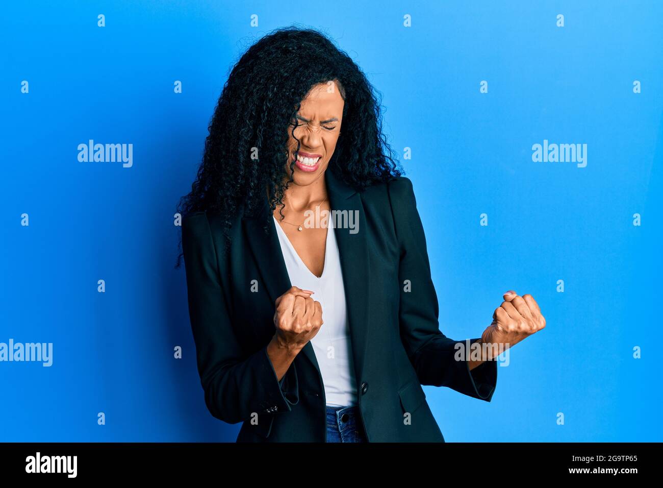 Middle age african american woman wearing business clothes excited for ...