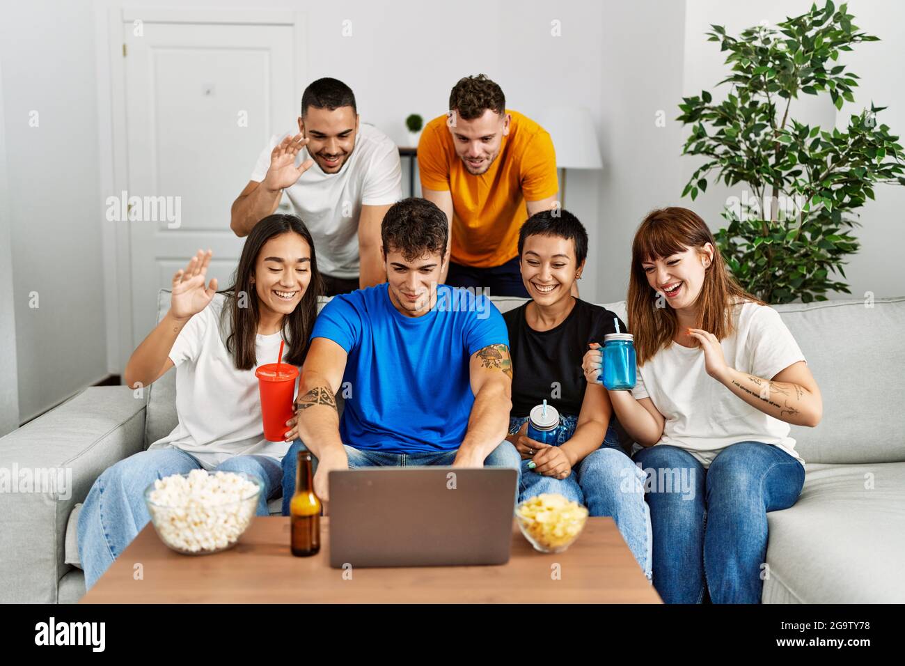 Group of young friends smiling happy having video call using laptop at ...