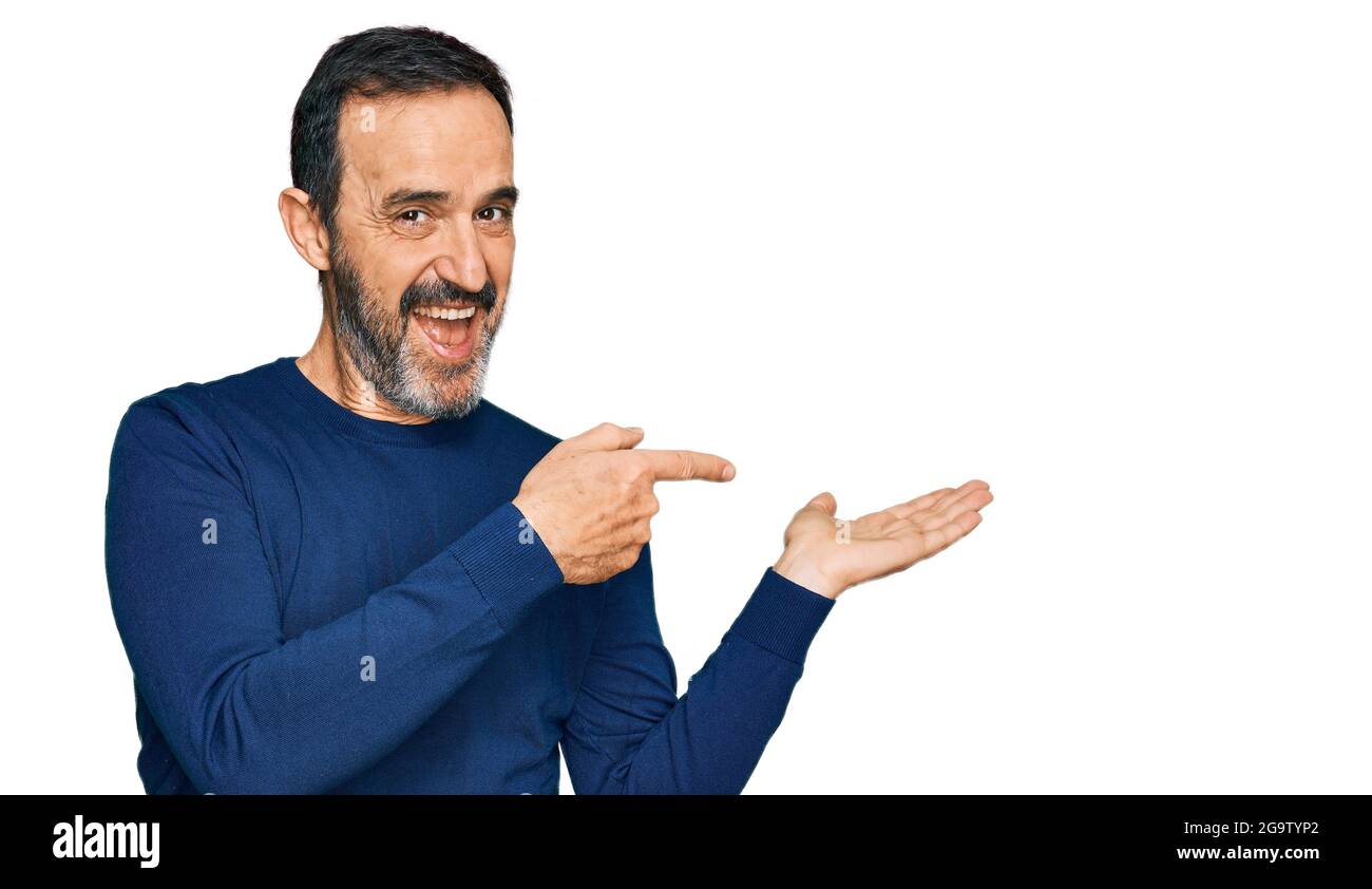 Middle Age Hispanic Man Wearing Casual Clothes Amazed And Smiling To 