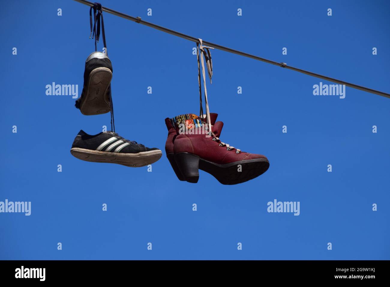 Shoes on a telephone line Stock Photo Alamy