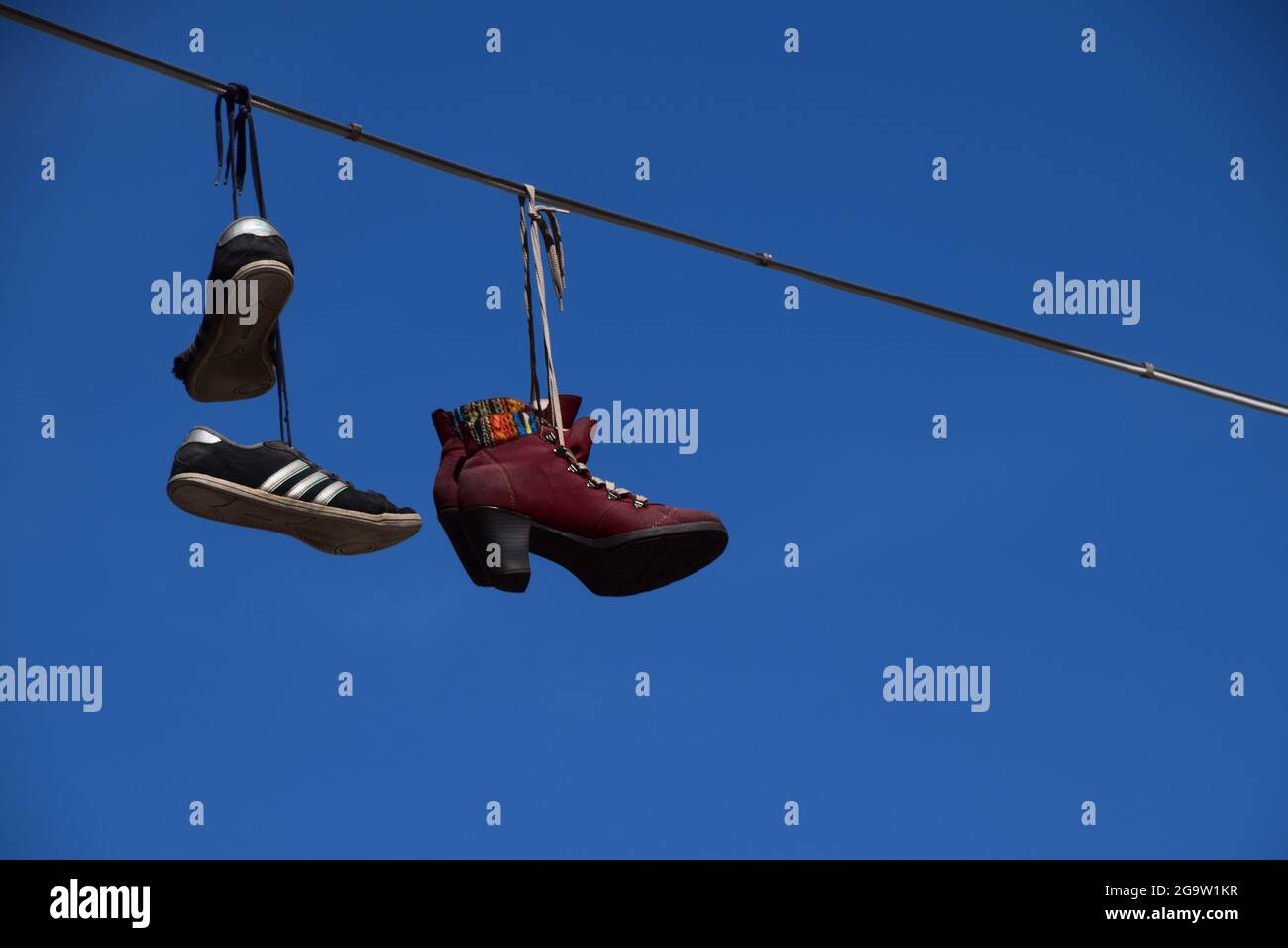 Shoes on a telephone line Stock Photo Alamy