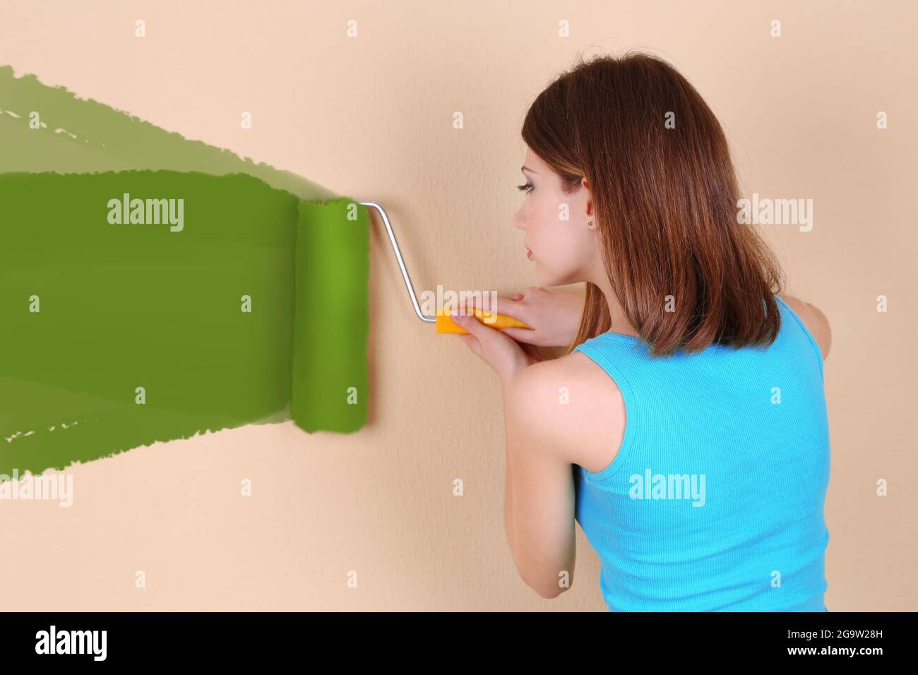 Beautiful girl paints wall in room Stock Photo Alamy