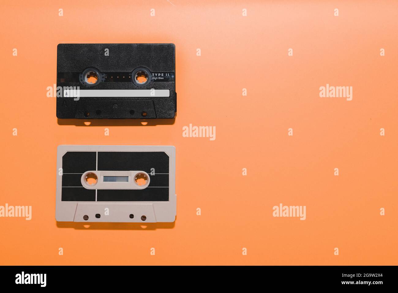 Two audio cassette tapes isolated on orange background. Copy space
