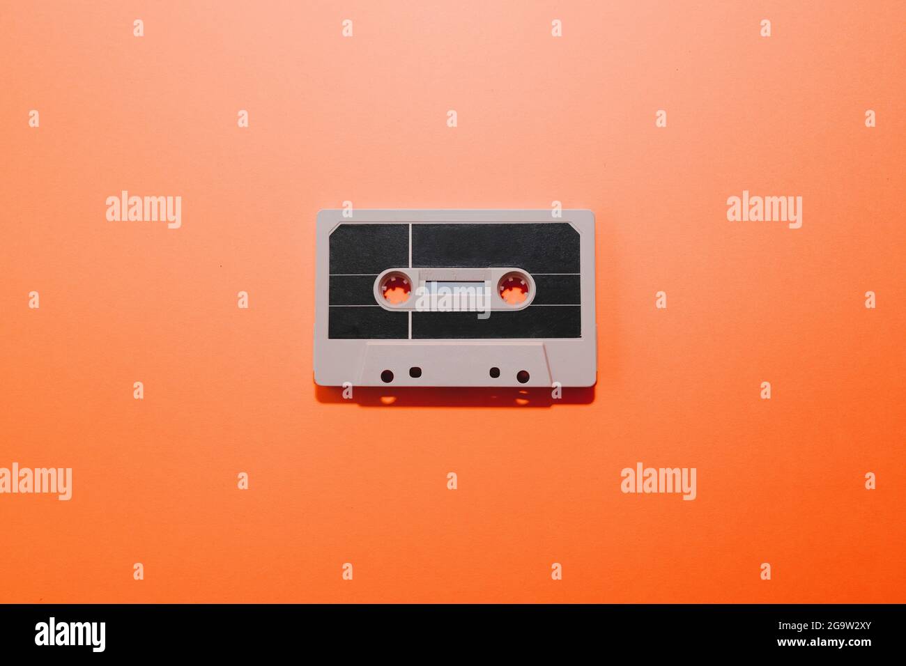 Audio cassette tape isolated on orange background. Copy space Stock