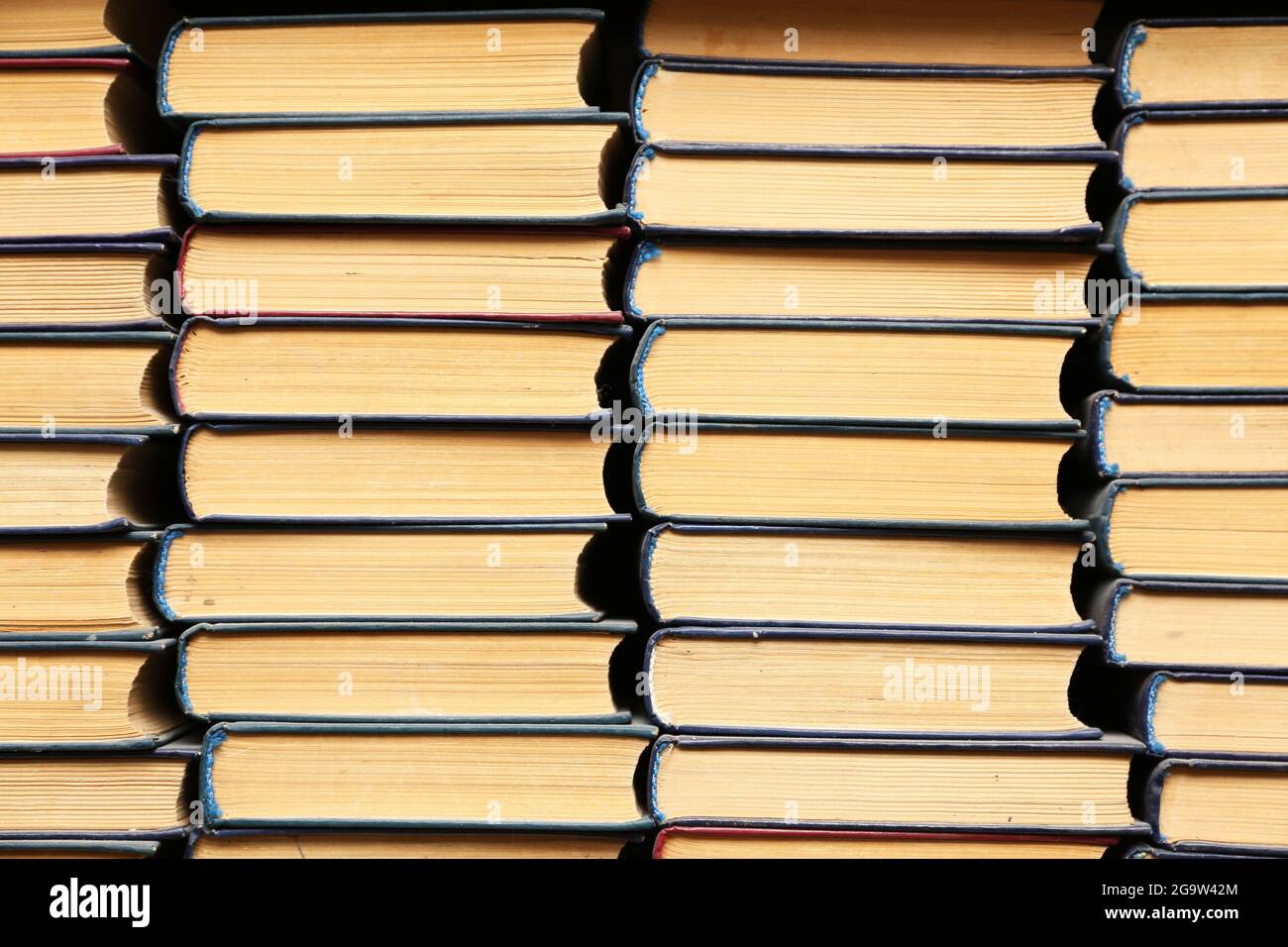 Stack of books in library Stock Photo - Alamy