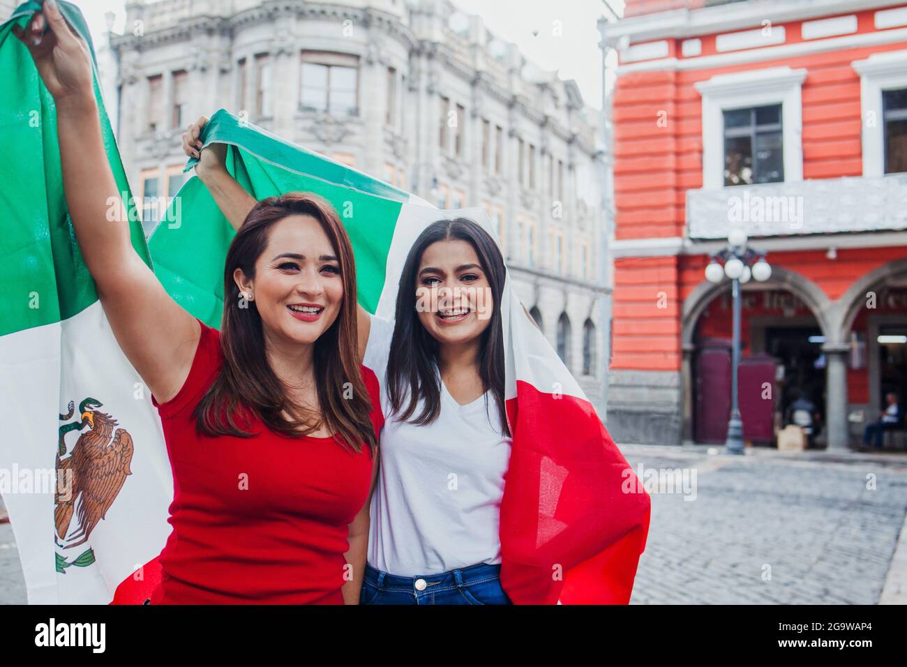 Mexican women with flags enjoying Mexican Independence Day party Stock Photo