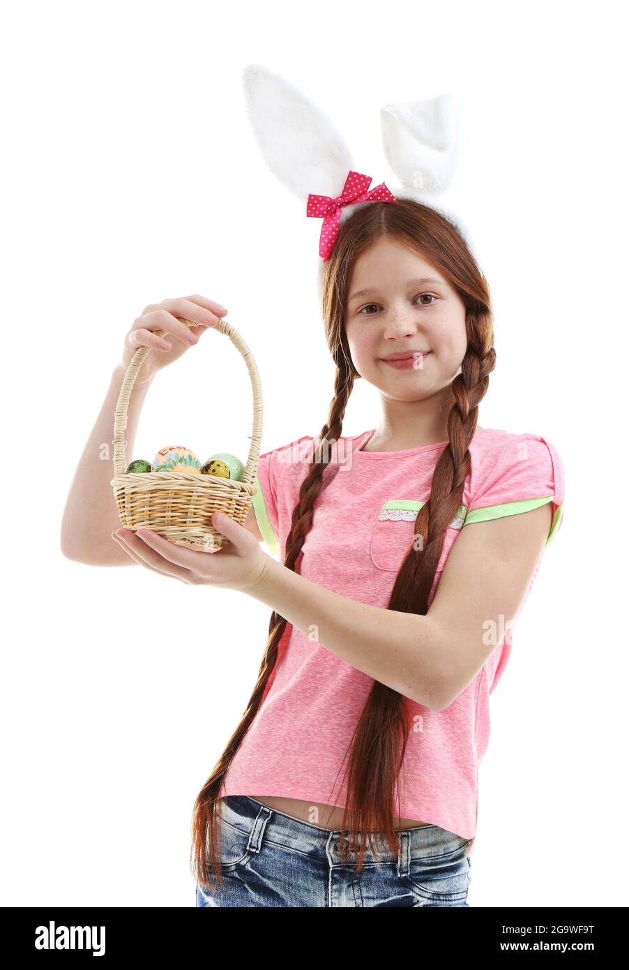 Beautiful little girl wearing Easter bunny ears and holding wicker ...