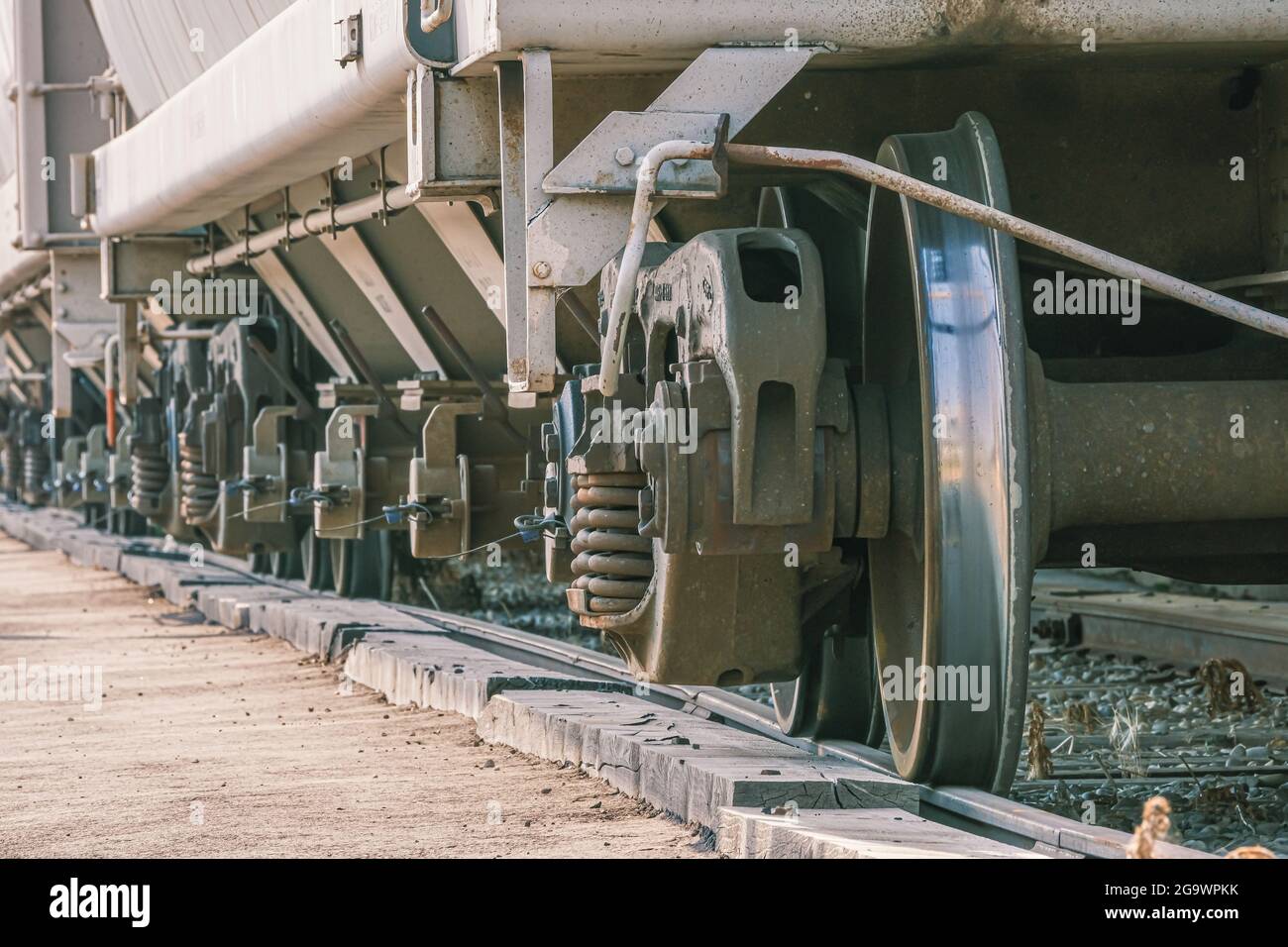 Freight train wheels on a siding next to a factory in industrial area
