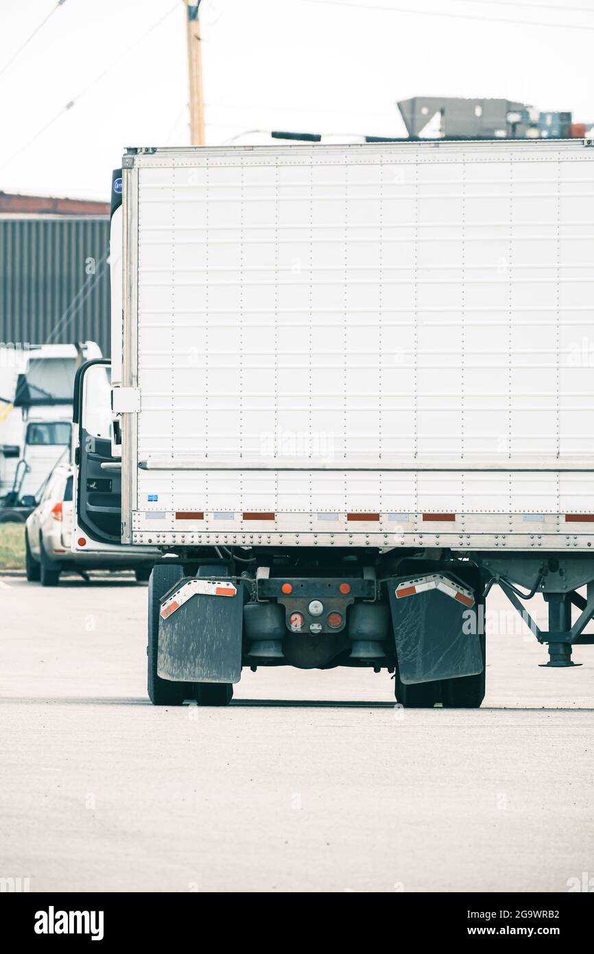 Semi Truck with Trailer in industrial parking lot in Calgary Stock