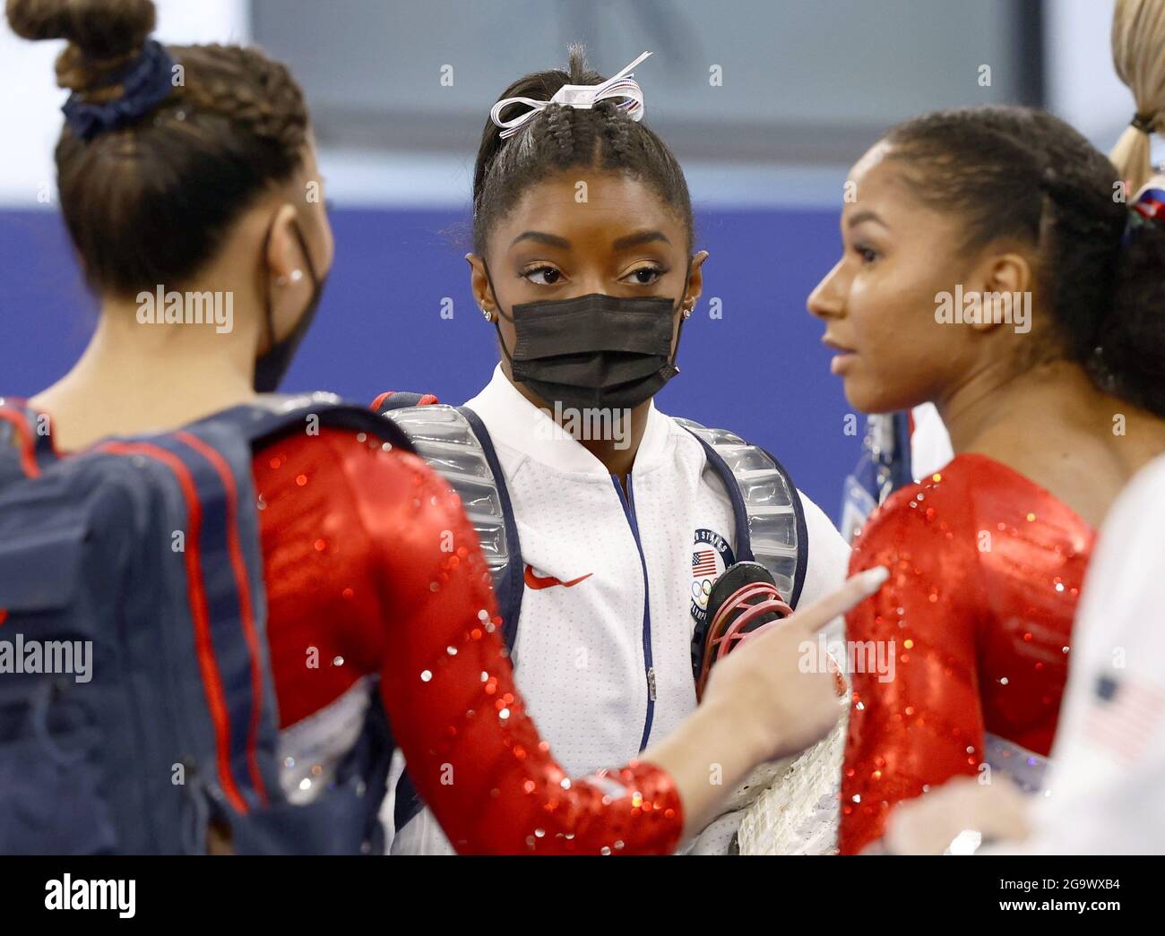 Simone Biles (C) of the United States speaks with teammates as she