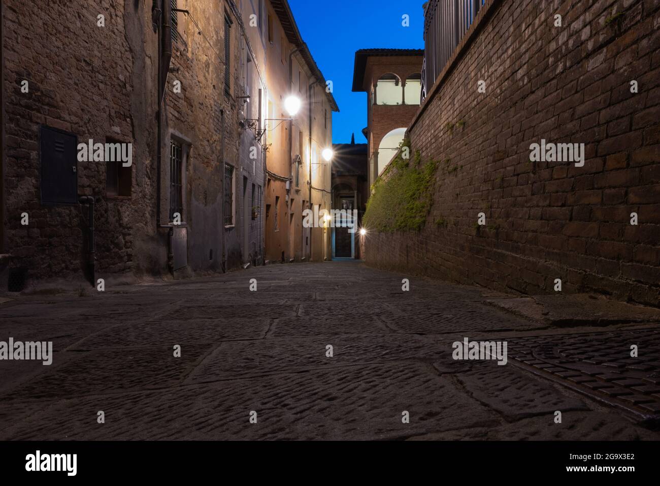 Street At Night In Siena Italy Stock Photo