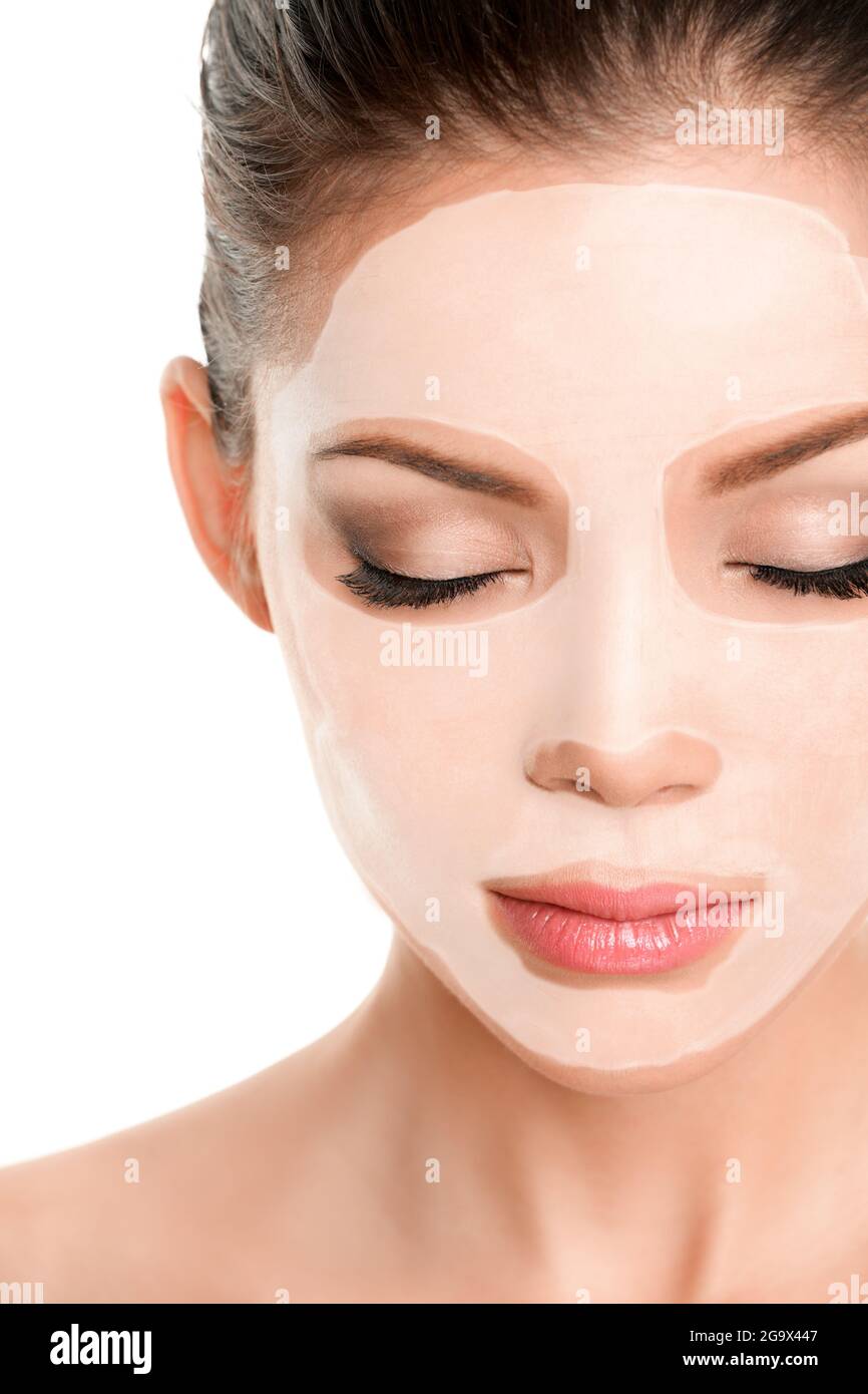 Collagen Hyaluronic Acid Mask facial rejuvenation Asian woman wearing white mud treatment sheet mask Stock Photo