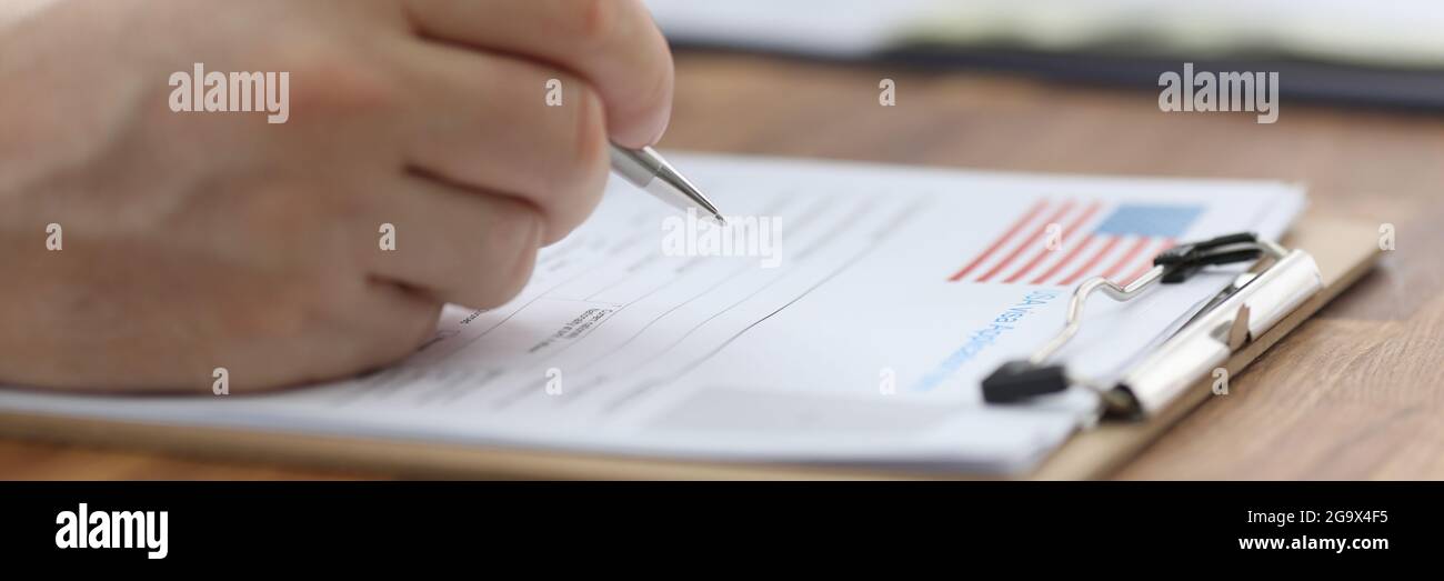 Man filling out documents for US visa closeup Stock Photo