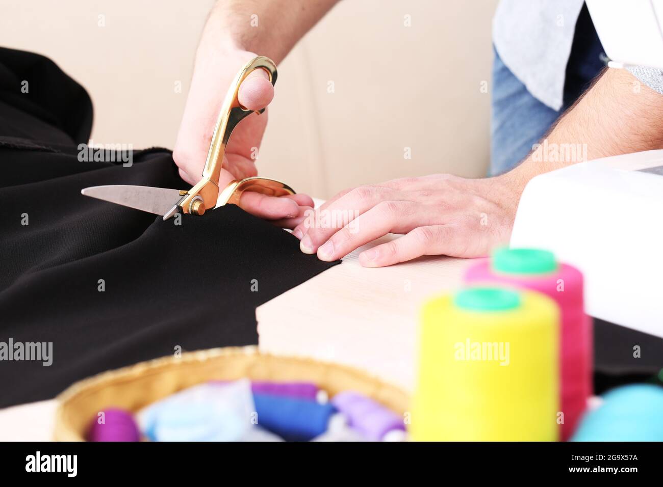 Male dressmaker cut fabric on table closeup Stock Photo Alamy