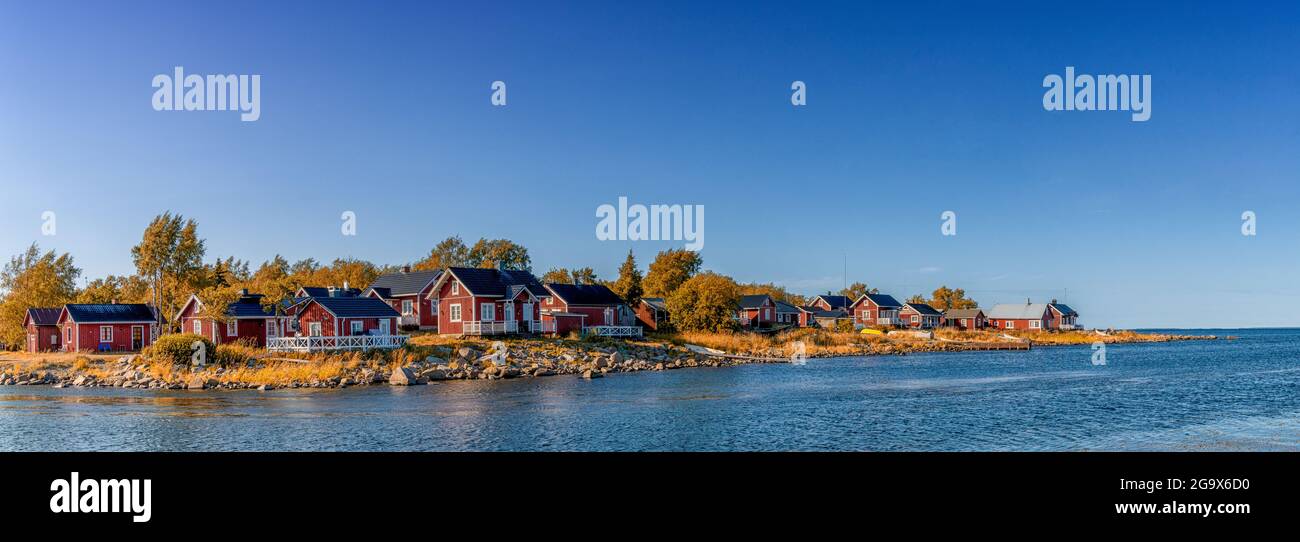 Ohtakari, Finland - 25 July, 2021: idyllic Baltic Sea panorama landscape with red cottages on the shoreline under a blue sky in autumn Stock Photo