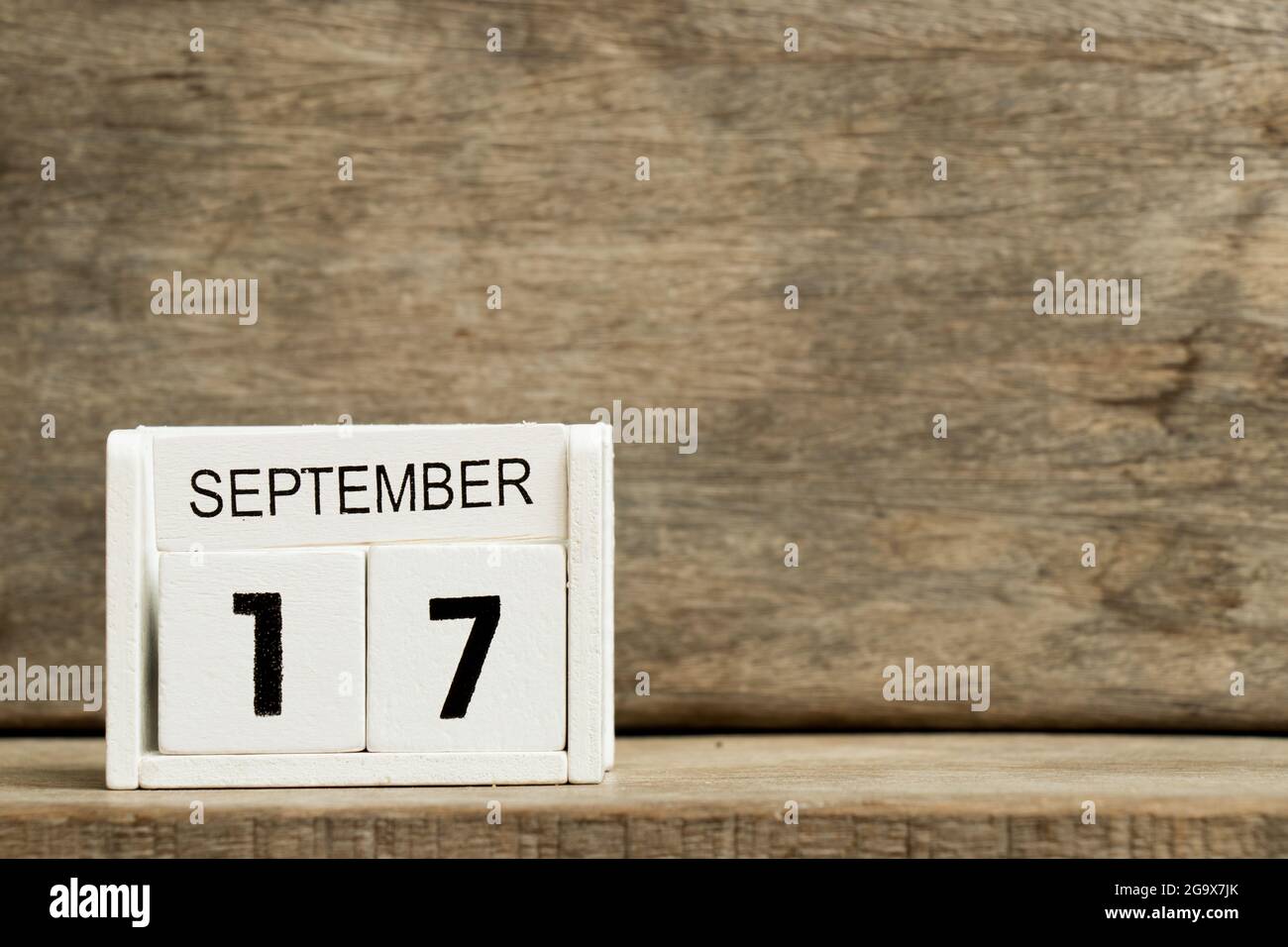 White block calendar present date 17 and month September on wood background Stock Photo