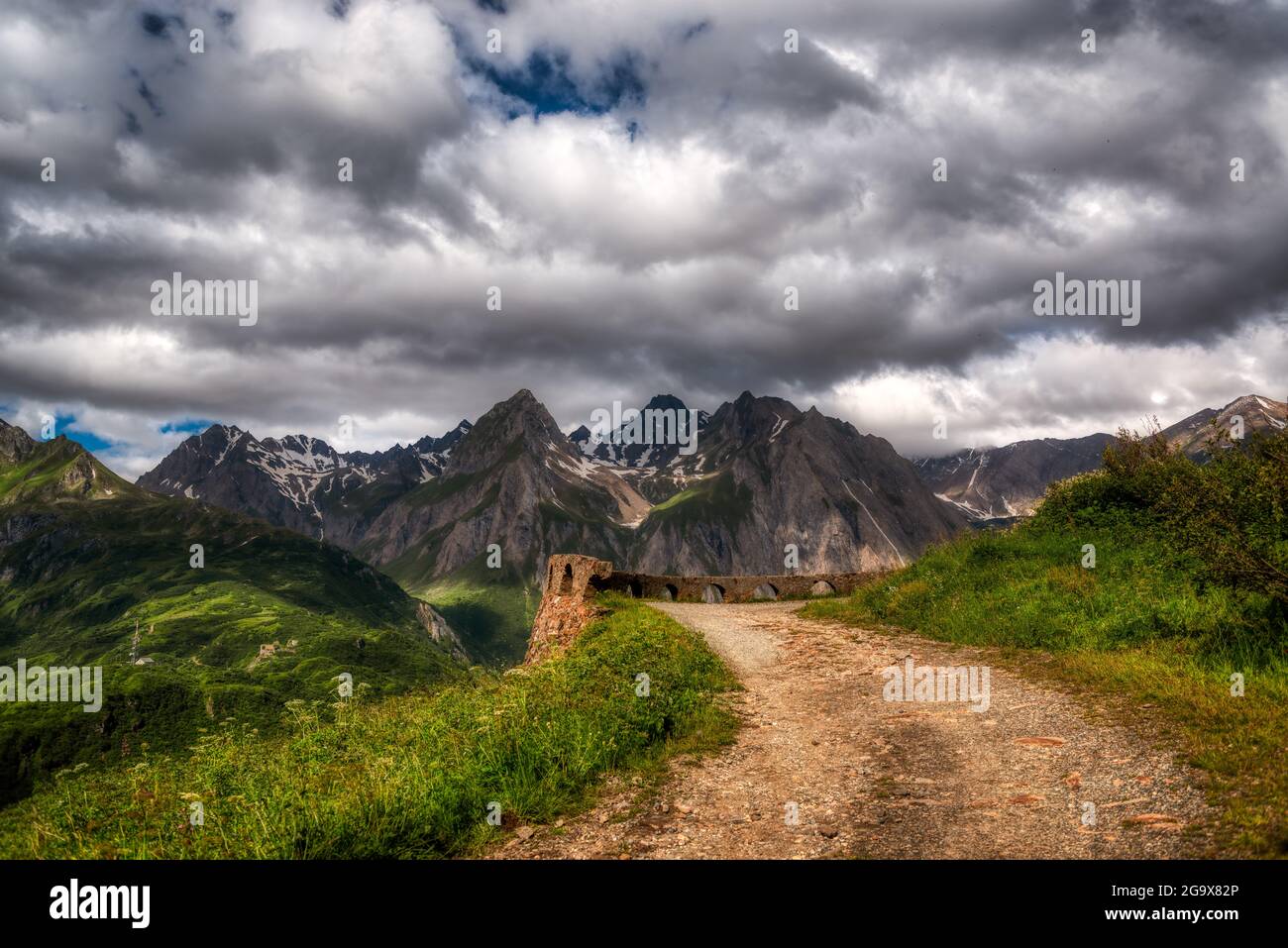 Path in the mountain with clouds in the sky Stock Photo