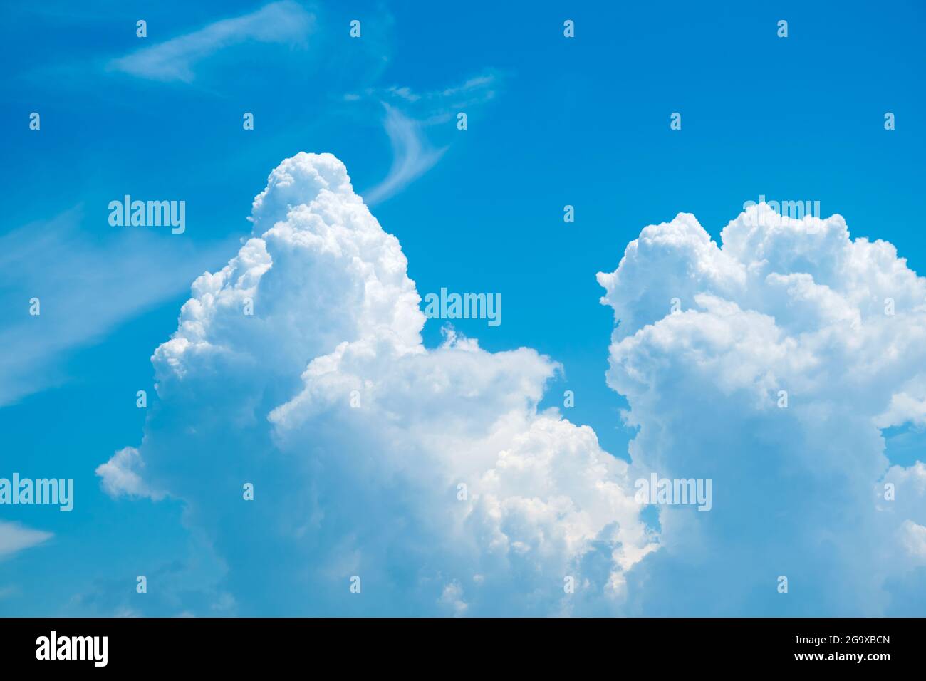 Blue sky background with fluffy clouds Stock Photo - Alamy