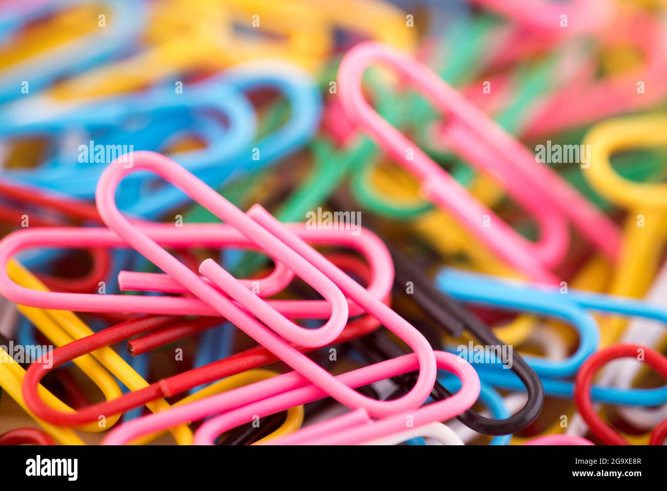 Pile of colorful paper clips macro abstract background Stock Photo