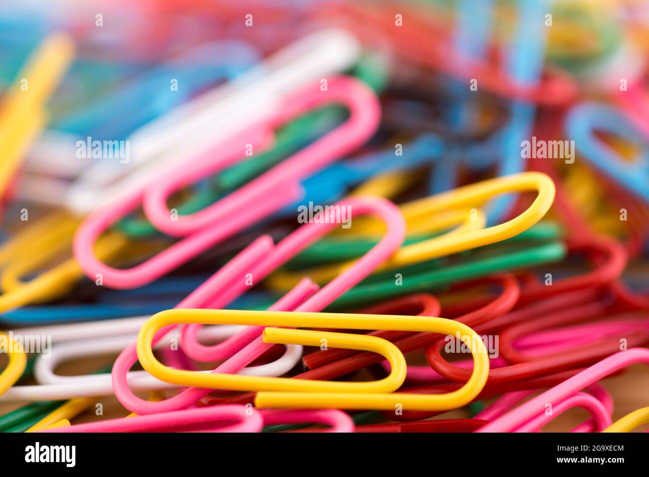 Pile of colorful paper clips macro abstract background Stock Photo