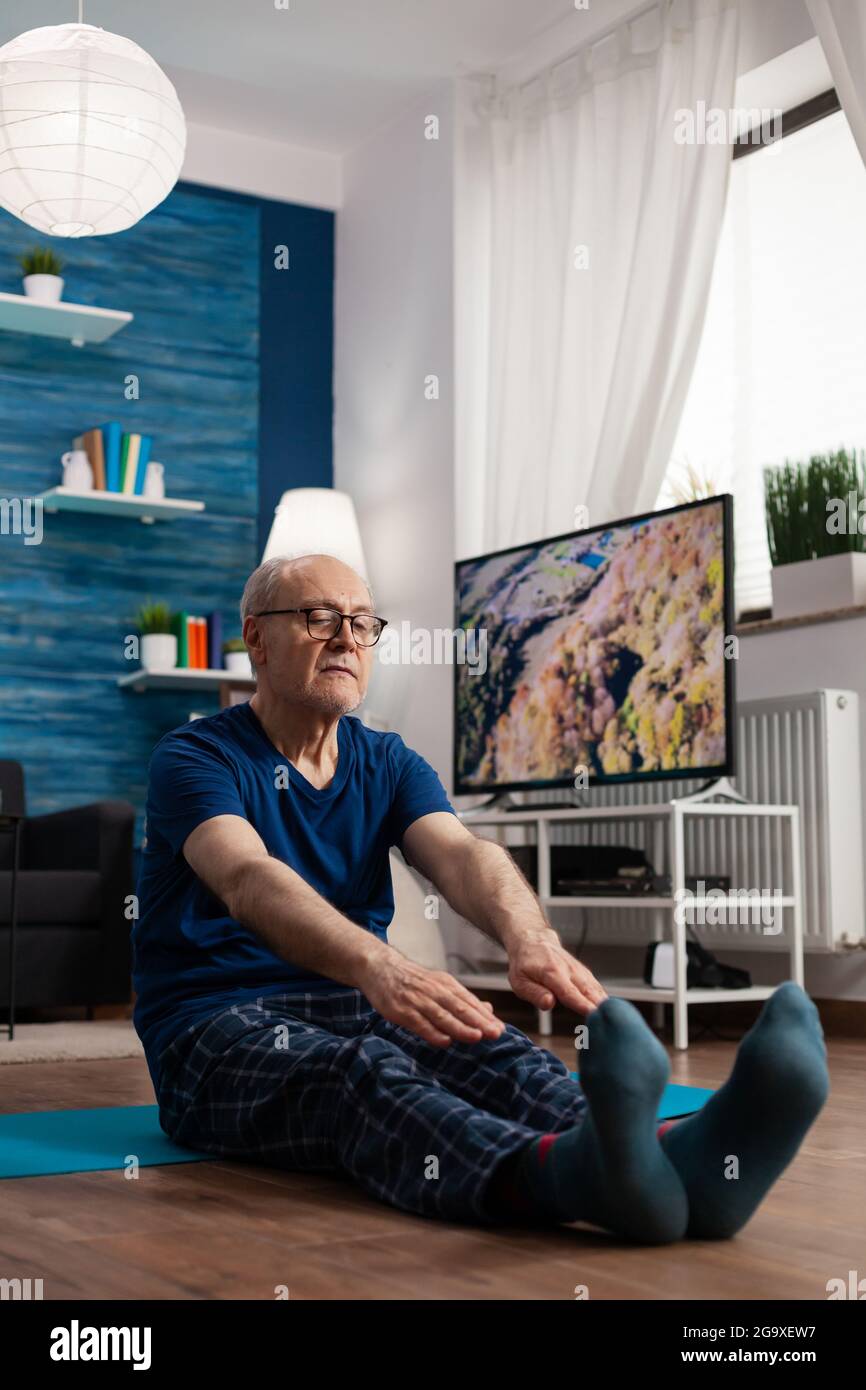 Man stretching leg on floor hi-res stock photography and images - Alamy