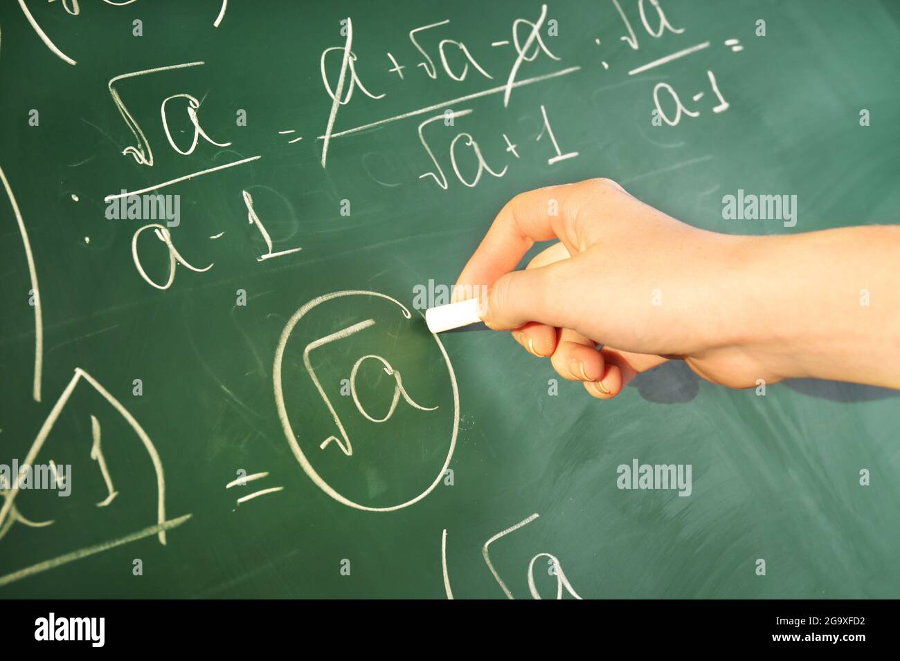 Teacher hand writing formulas on blackboard background Stock Photo - Alamy