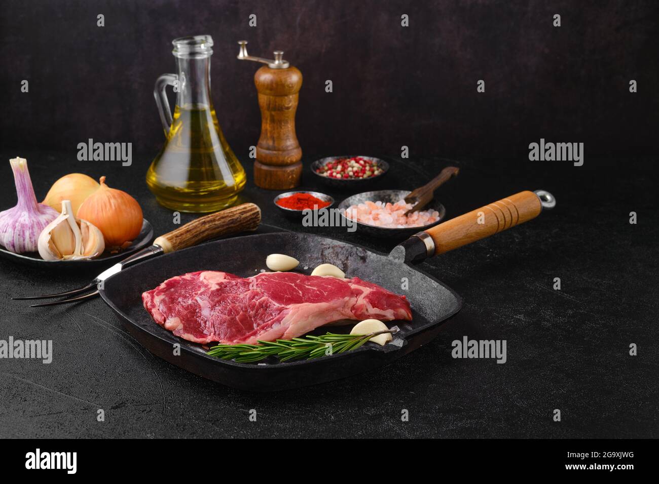 Raw ribeye steak, premium beef boneless meat on castiron pan Stock