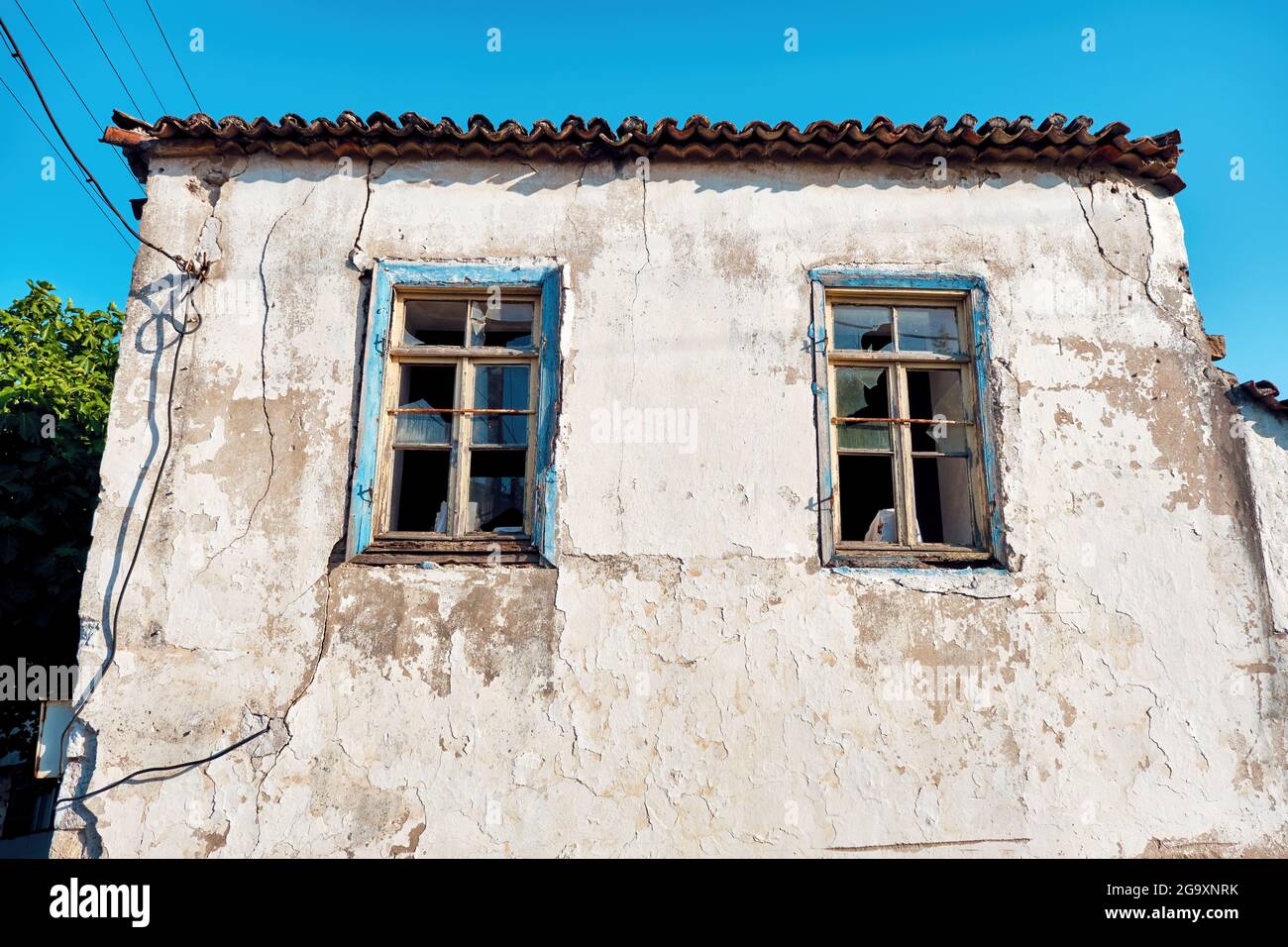 Abandoned stone house with broken windows. Stock Photo