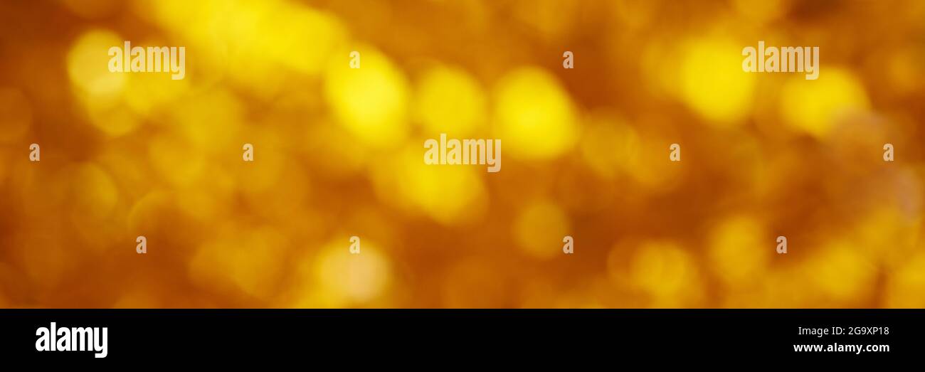 Golden colored blurred background. Abstract background with bokeh. Stock Photo