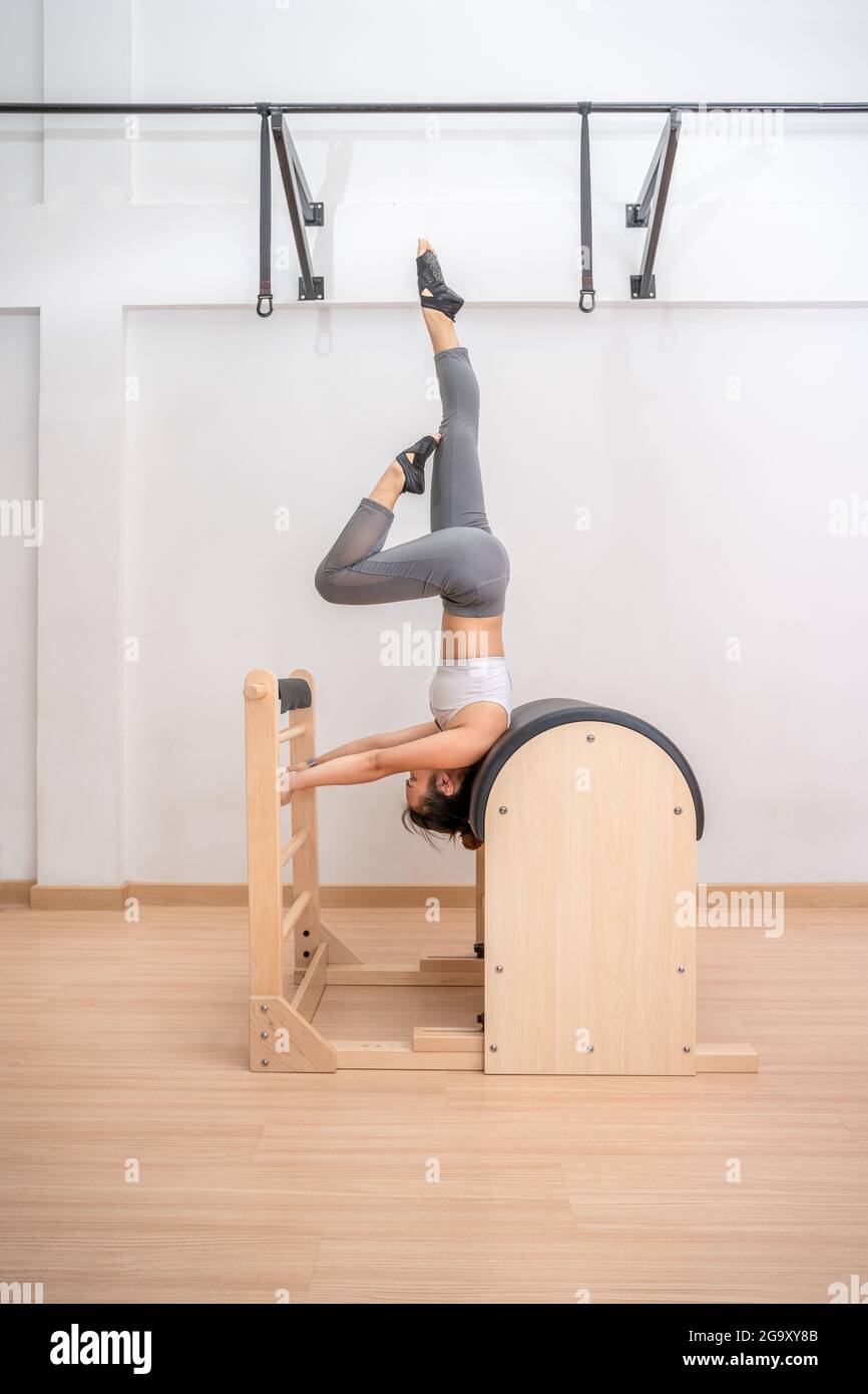 Young Asian woman working on pilates ladder barrel machine during her  health exercise training Stock Photo - Alamy