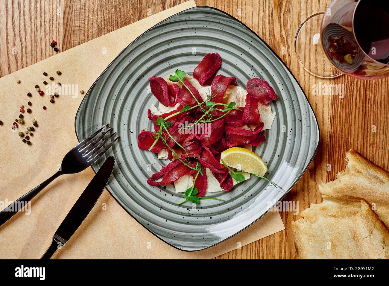 Sliced spicy air-dried basturma with flatbread and red wine Stock Photo