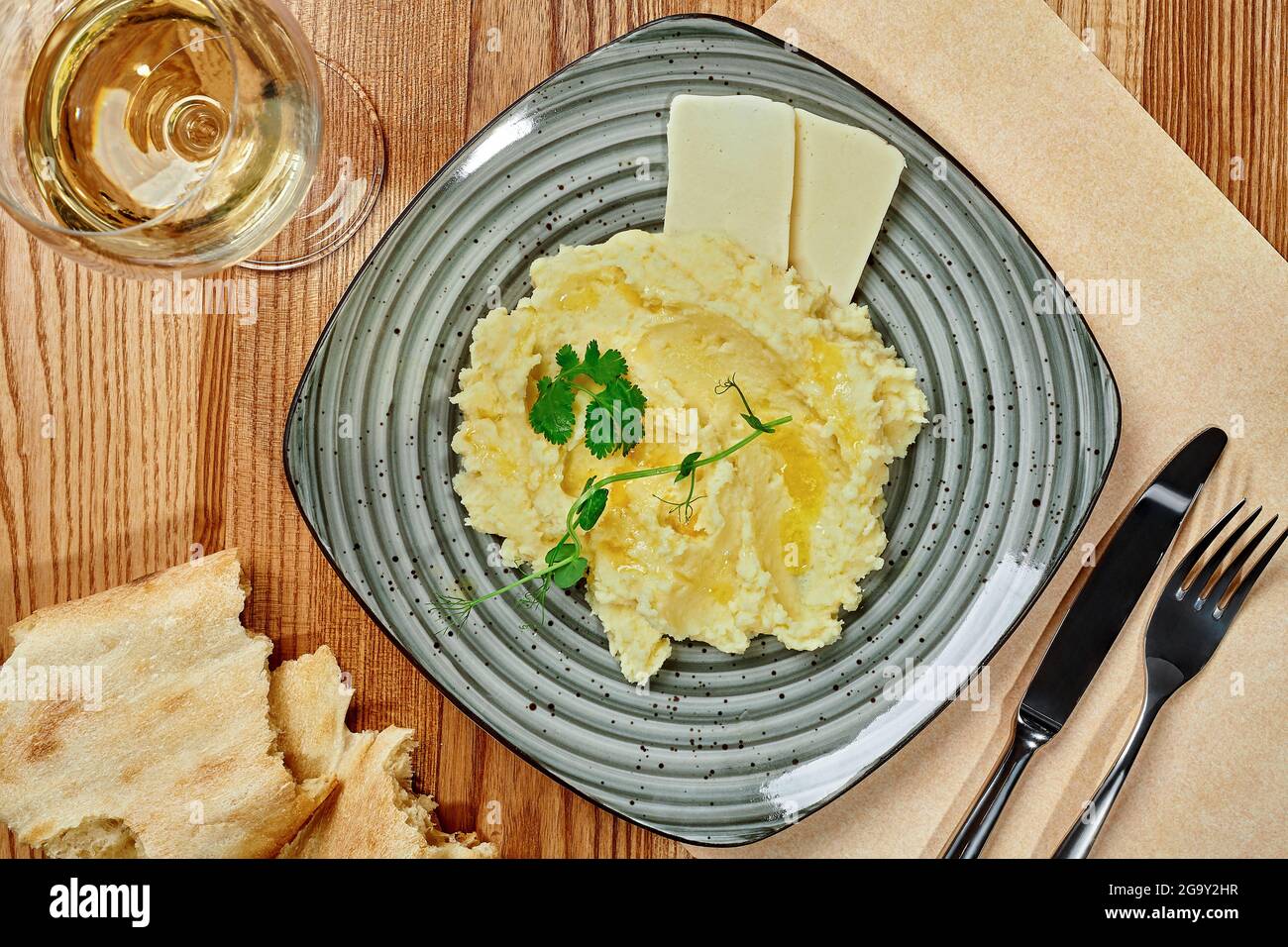 Creamy mashed potatoes with sulguni cheese, shotis puri and white wine Stock Photo