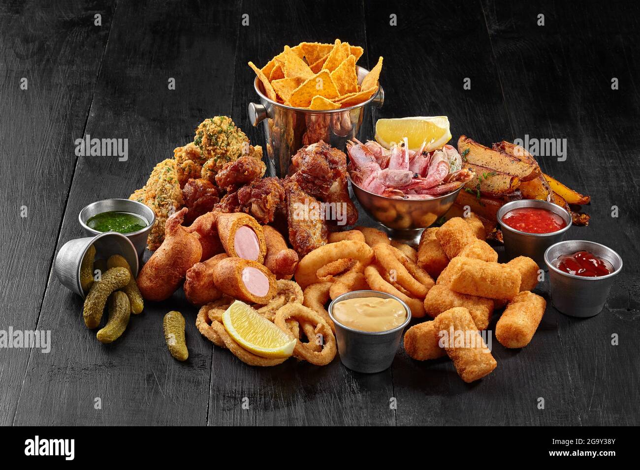 Fried chicken wings, battered sausages, onion rings, cheese sticks