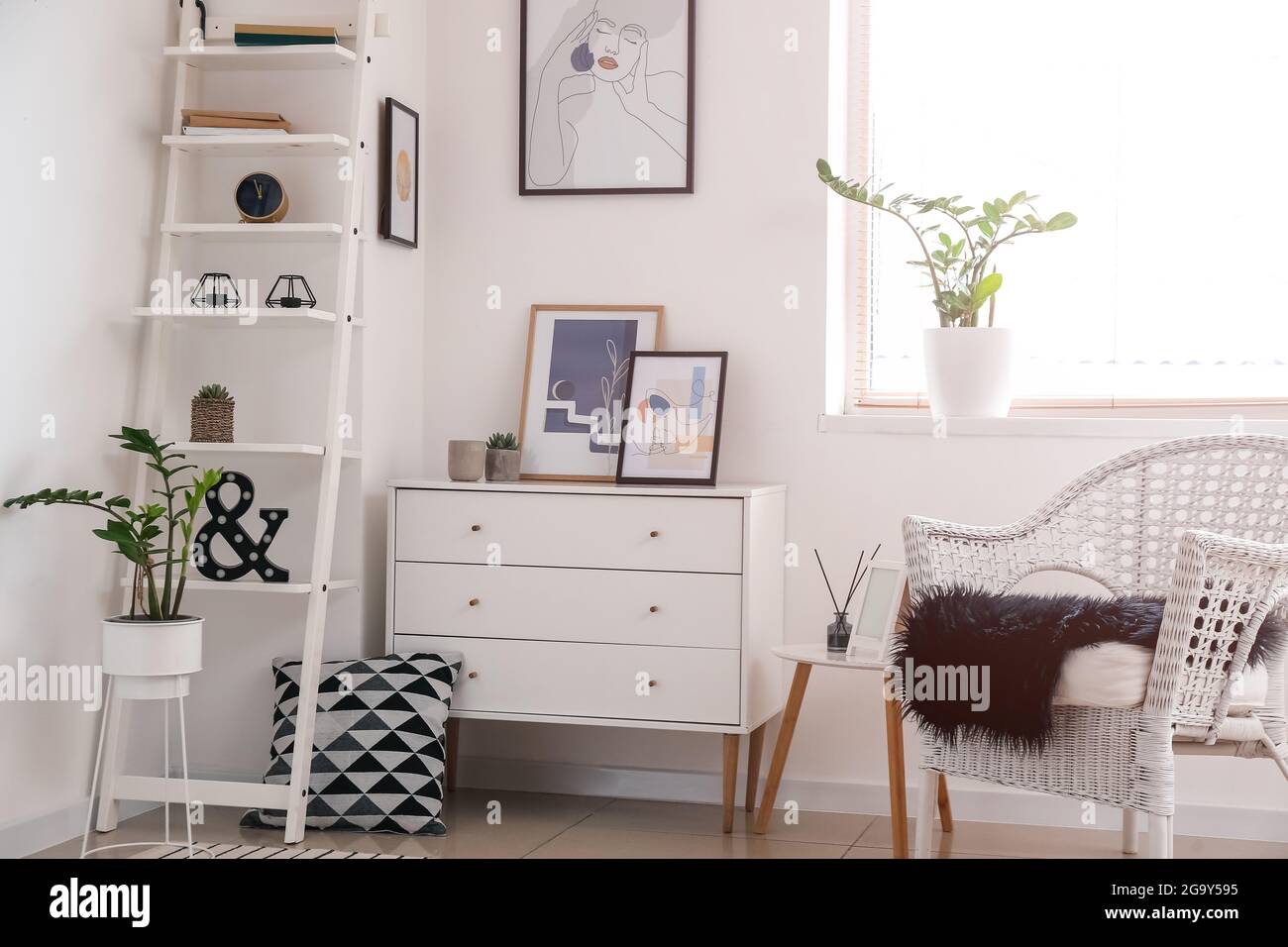 Interior of stylish living room with pictures Stock Photo - Alamy