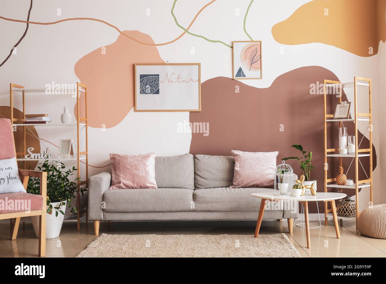 Interior of stylish living room with pictures Stock Photo - Alamy