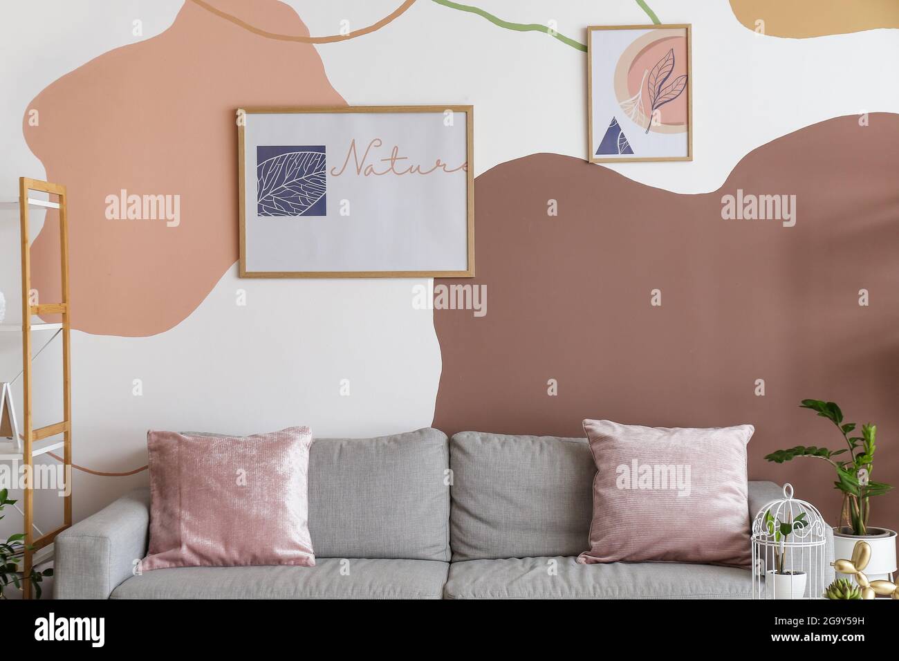 Interior of stylish living room with pictures Stock Photo - Alamy