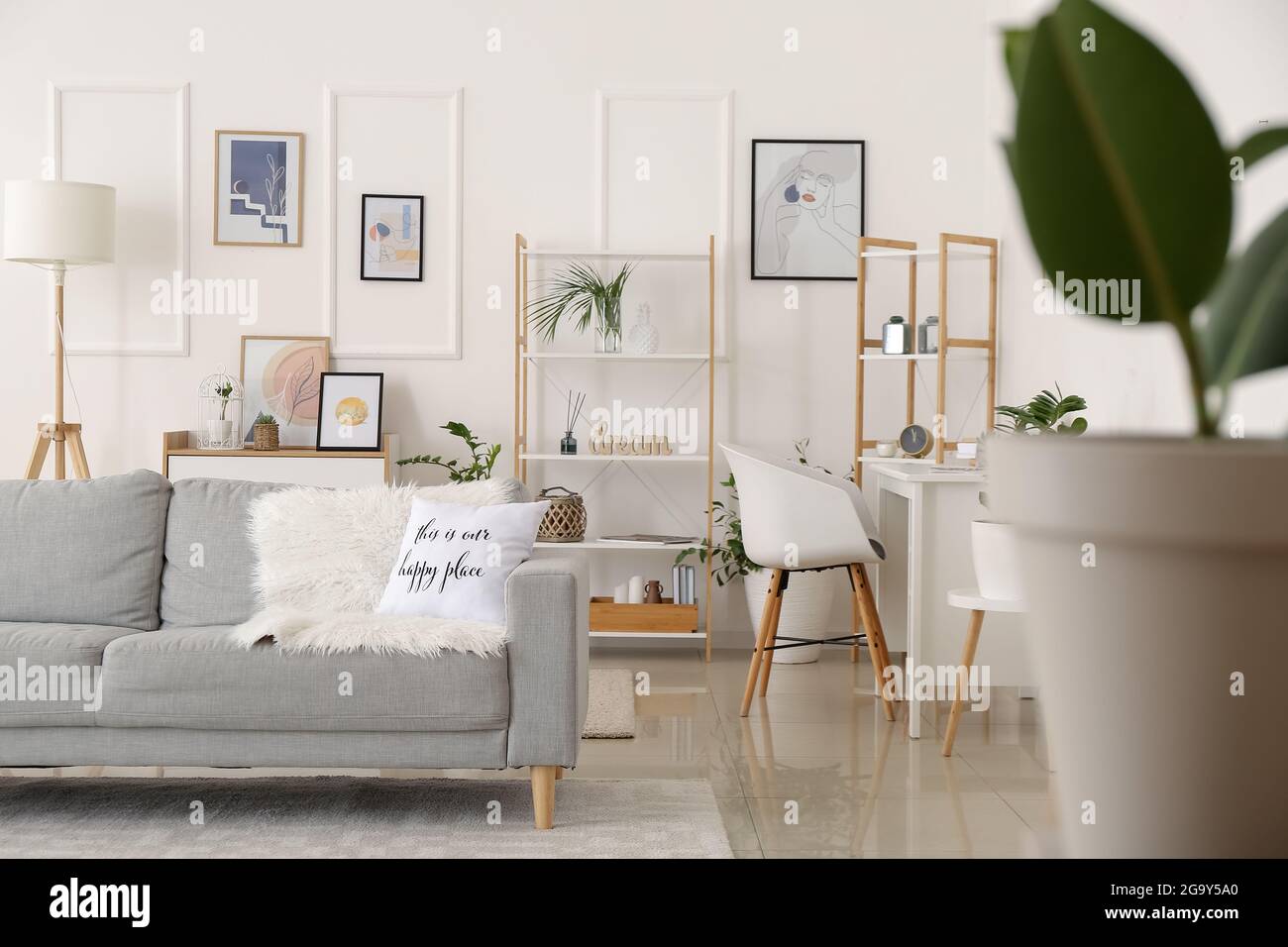 Interior of stylish living room with pictures Stock Photo - Alamy